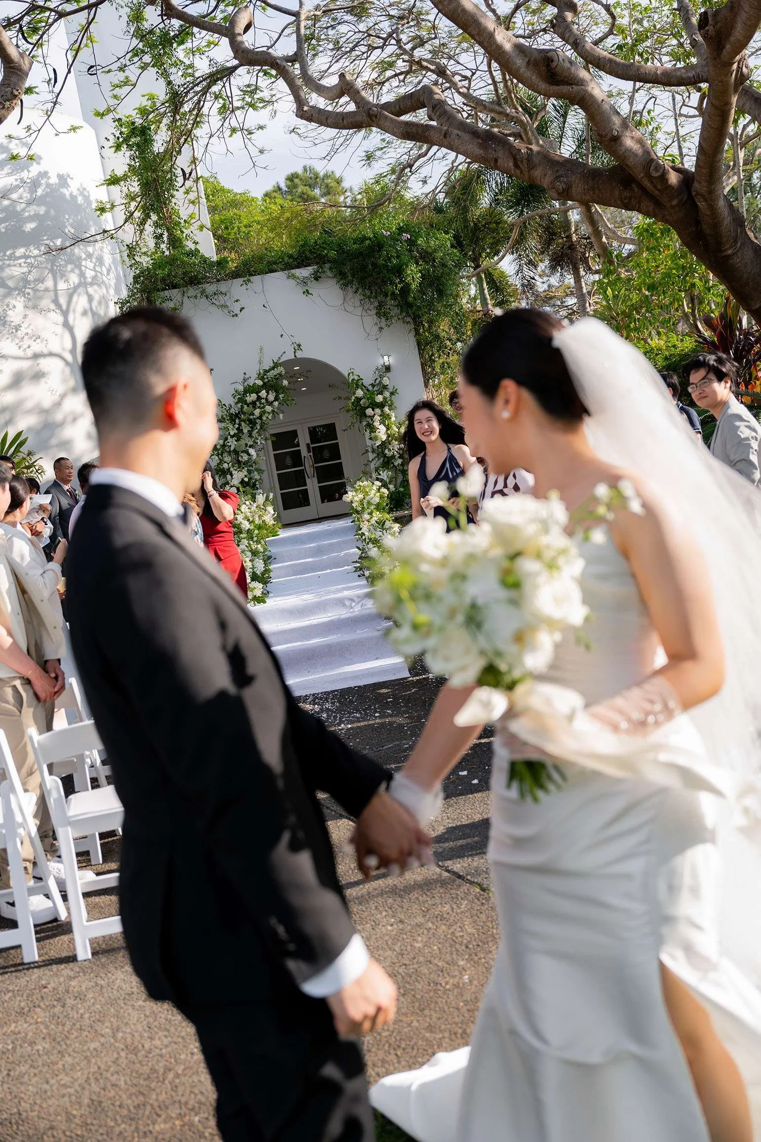 Wendy and Alex holding hands and look back to the audience after the ceremony