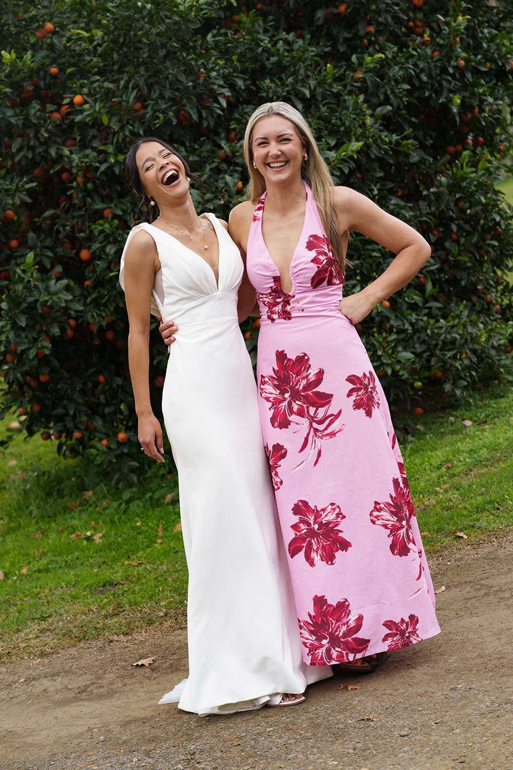 Jasmin holding Sarah's waist and they both laughing