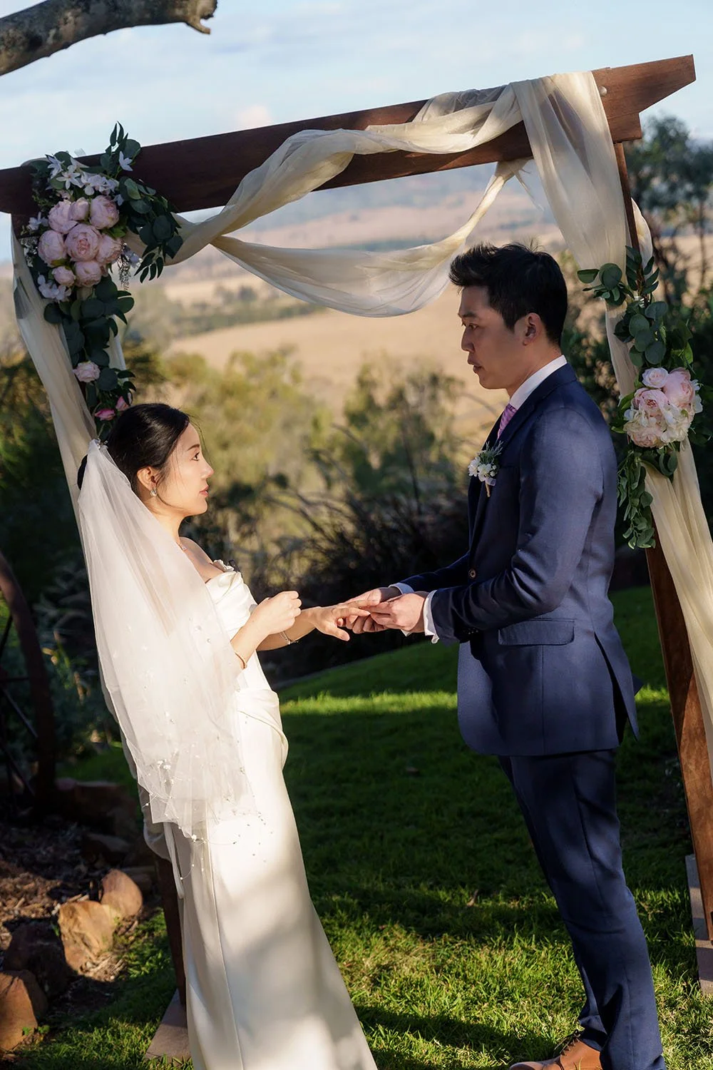groom Eric put on the wedding ring for bride and they made a eye contact