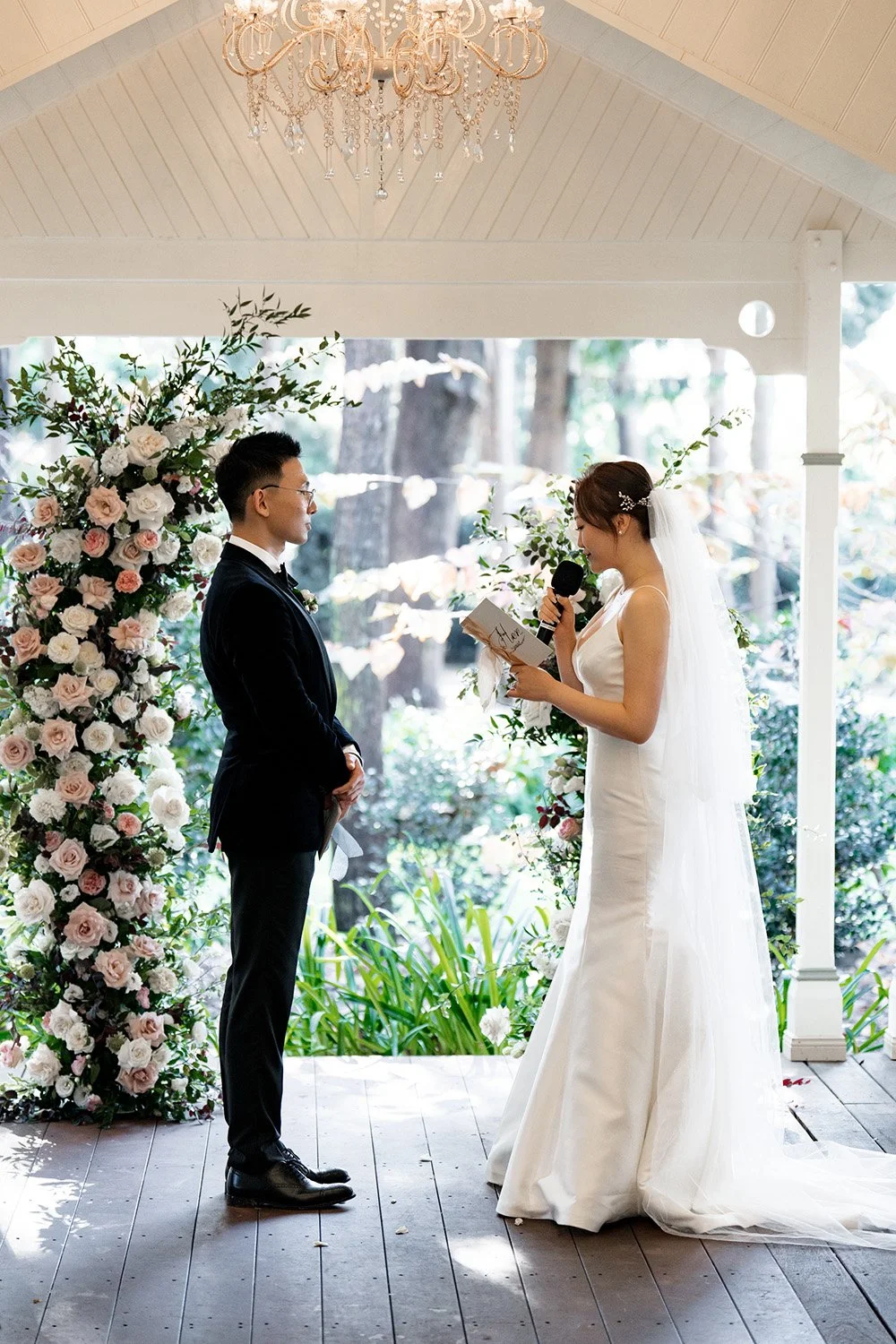 bride Vicky reading her vows when groom Brus look at her in wedding ceremony