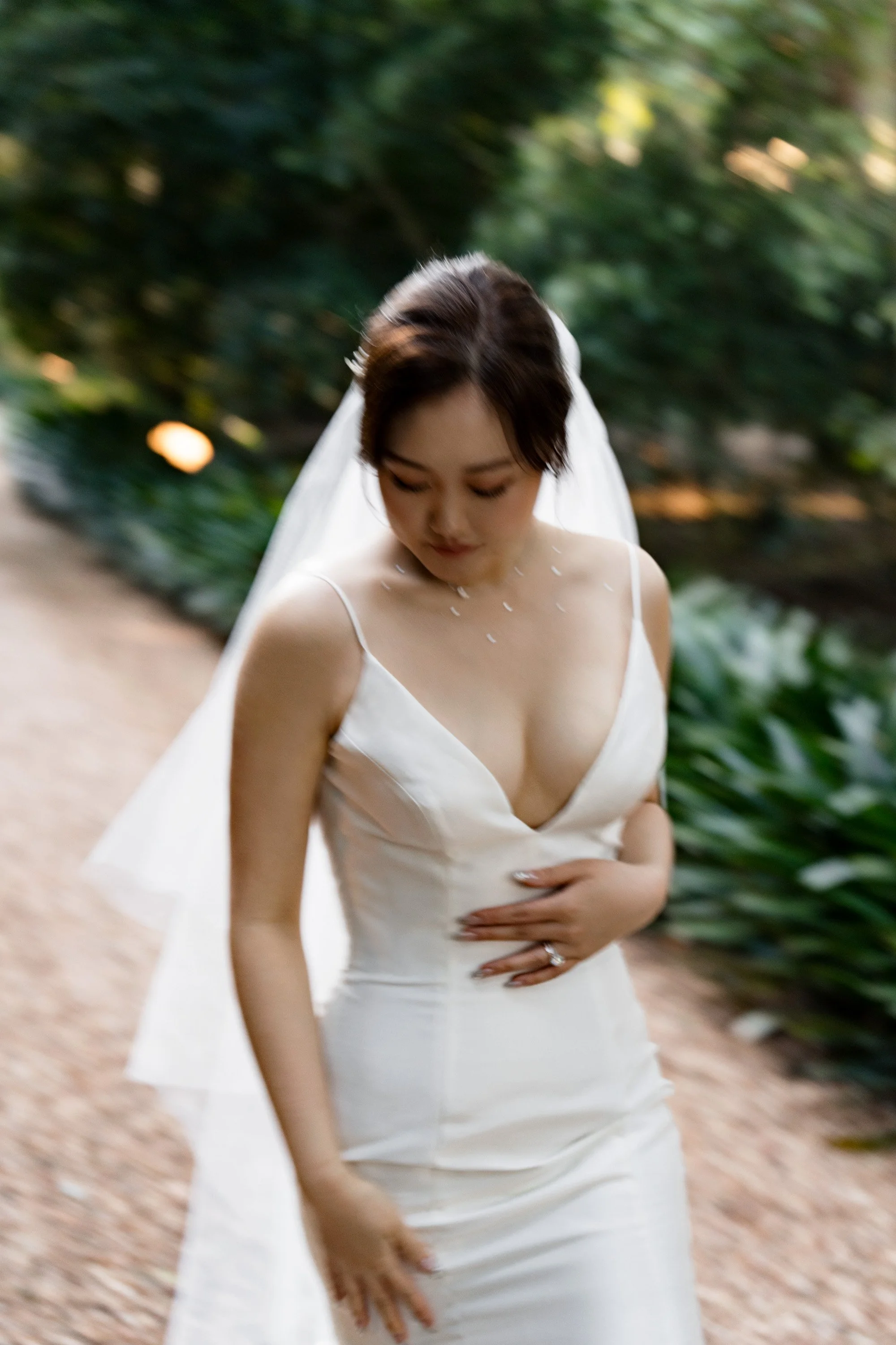bride Vicky walking towards to the Brisbane wedding photographer with eyes look down in Gabbinbar Homestead