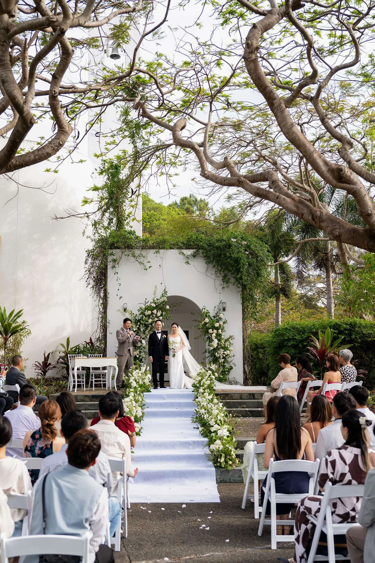 Wendy and ALex hands holding and facing to their guests in wedding ceremony