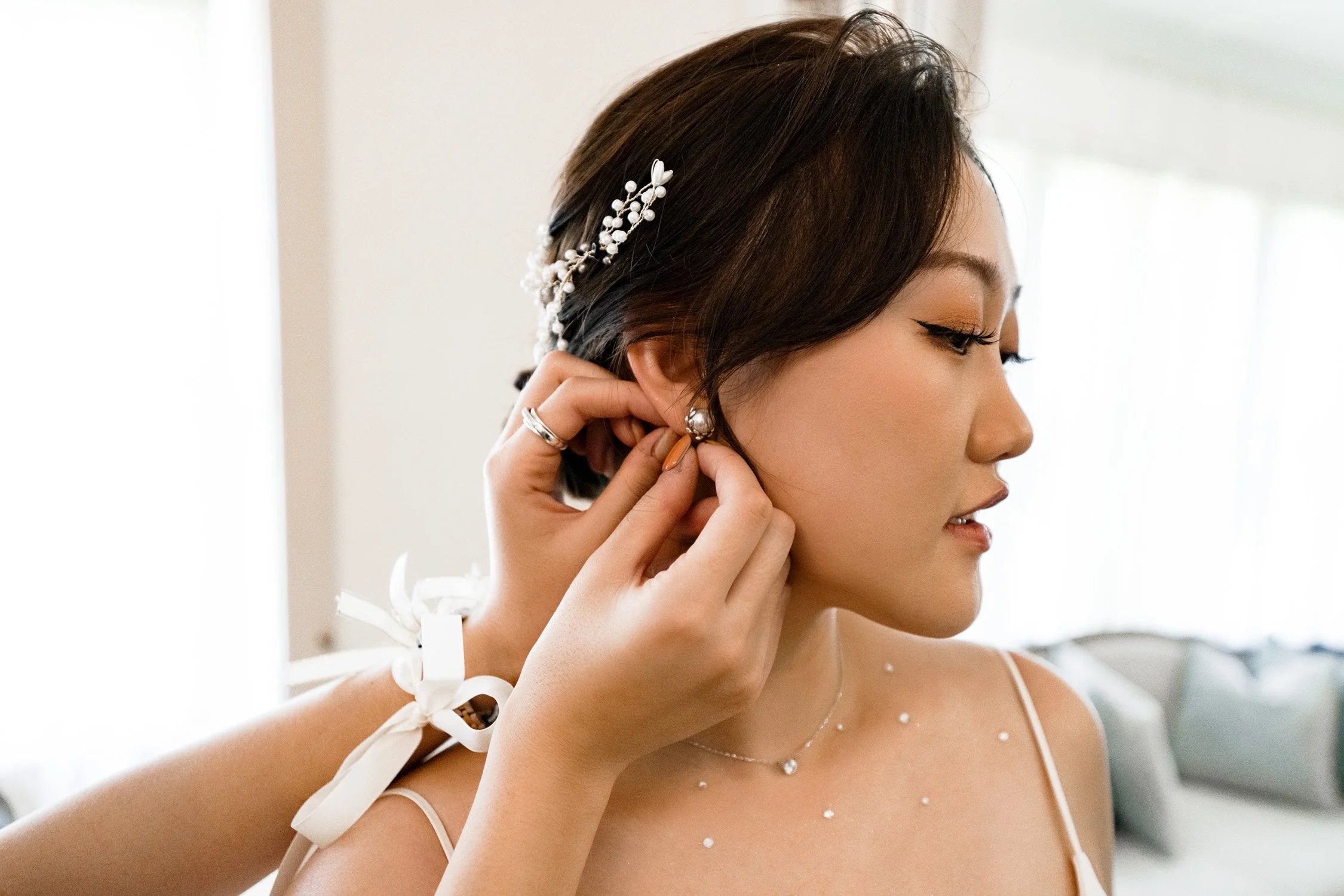 maid of honour put on the earing for bride Vicky in gabbinbar homestead