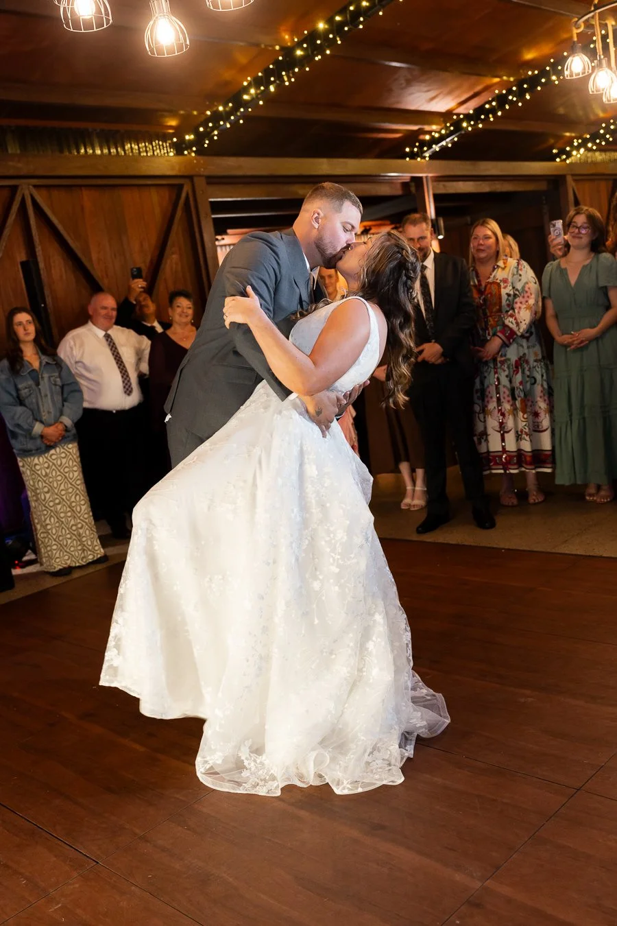 groom Ben dipping bride and kissing her in their dancing floor