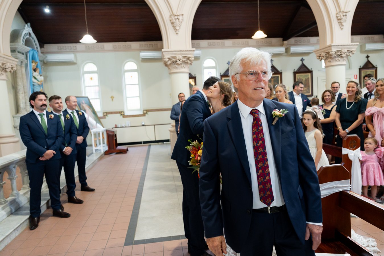 The bride’s father stepped aside as he gave the bride’s hand to the groom