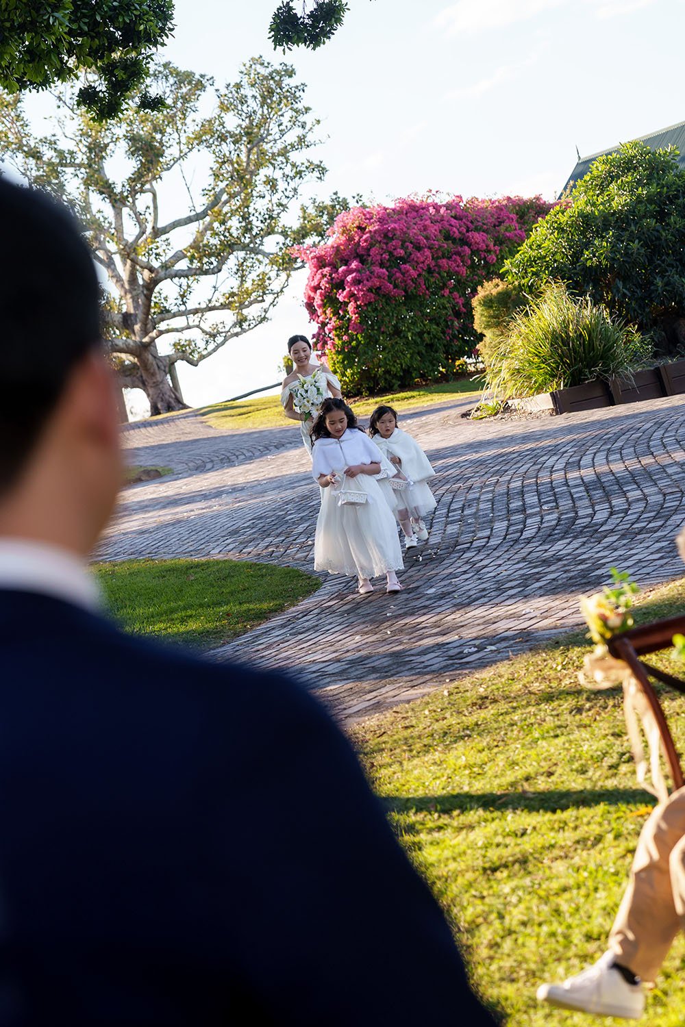 Flora walking down the ailse leading by three flower girls