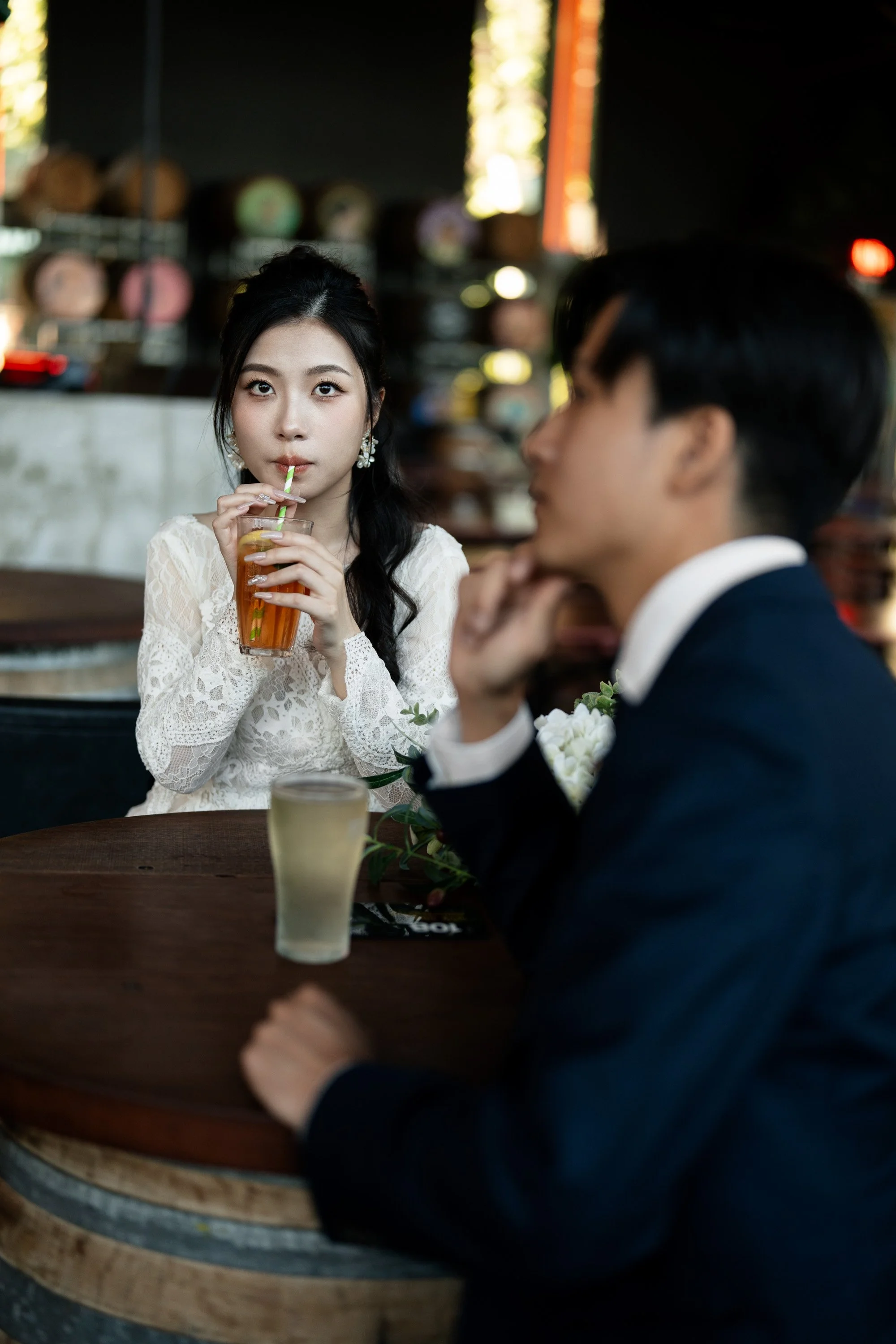 bride Cassie using a straw to drink a lemon lime bitters when look at the Brisbane wedding photographer Whistler