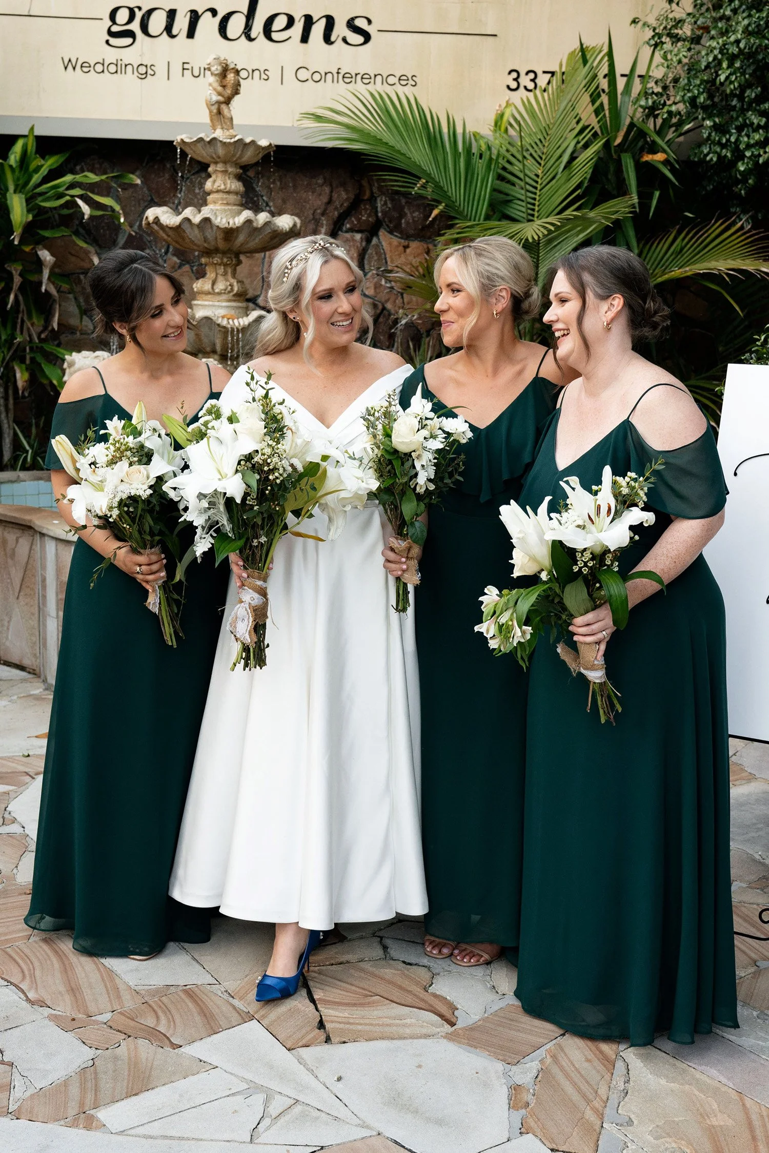 Kyra's bridesmaids looking at her and laughing, standing together in a joyful and heartfelt moment before the wedding.