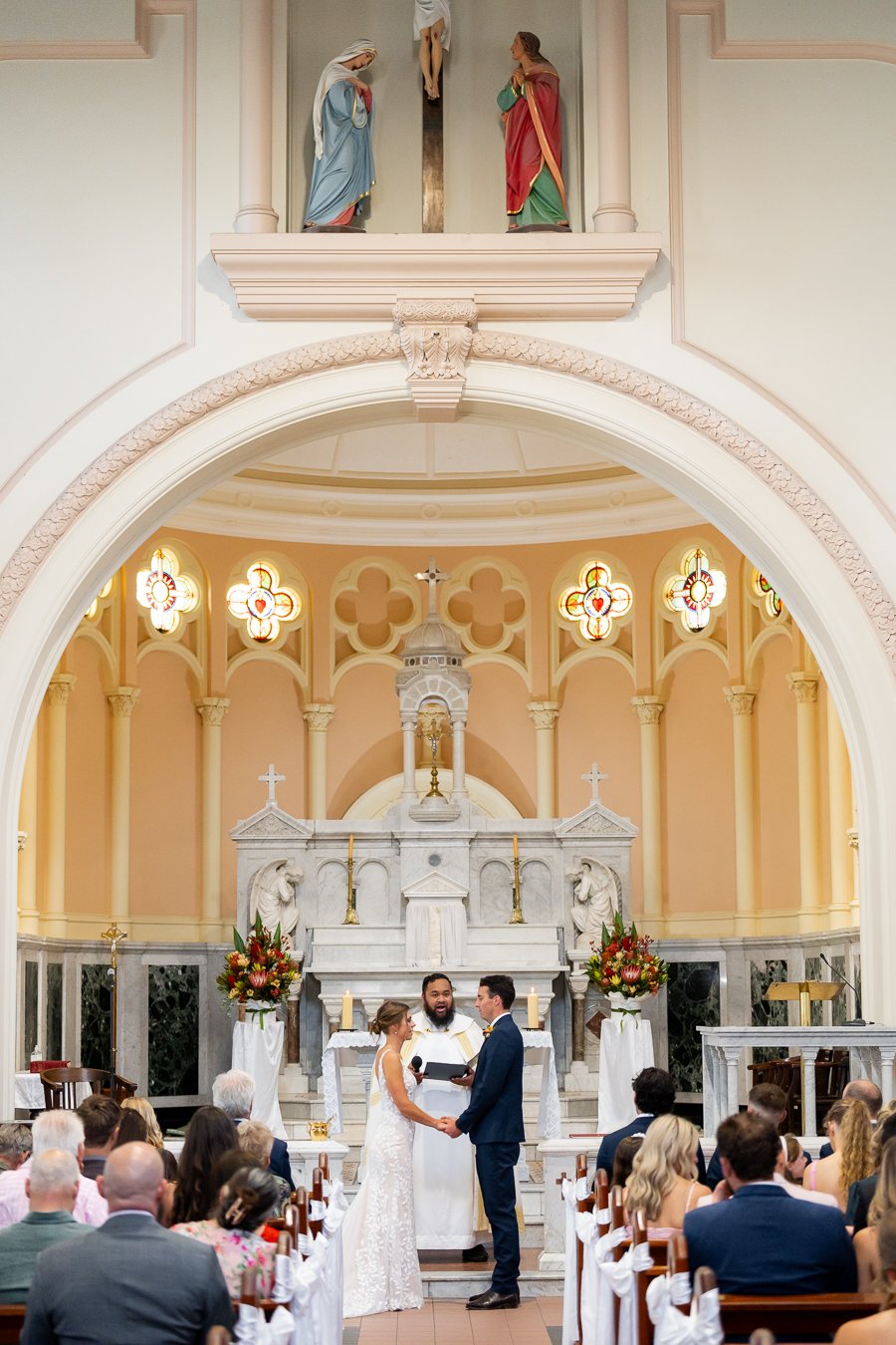 The bride and groom stood facing each other during the ceremony, with the officiant standing between them