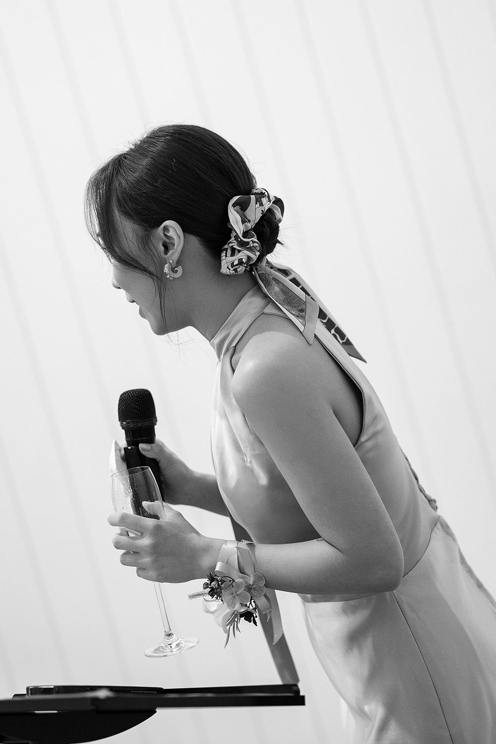 Lisa's maid of honour speak on a mic