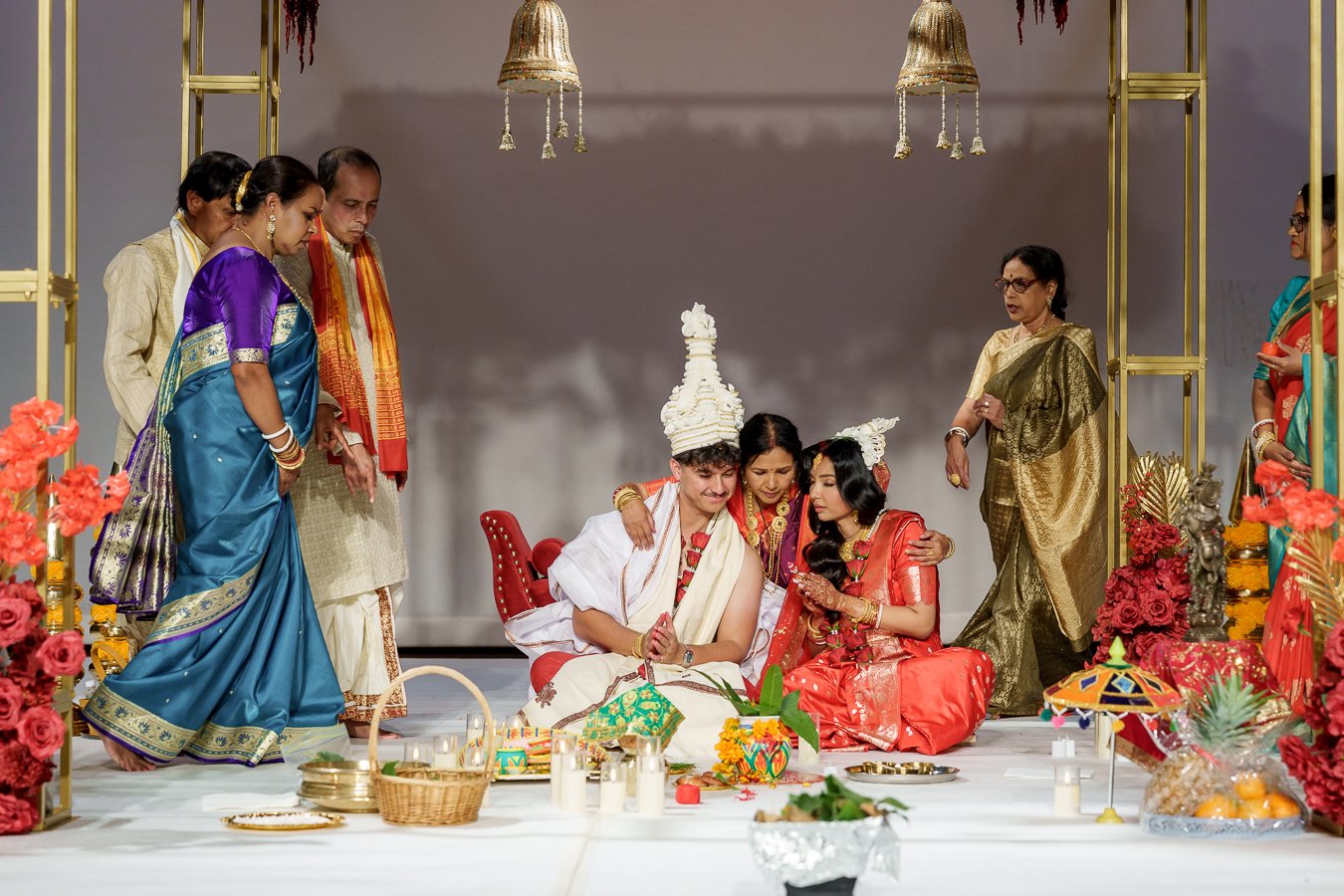 Amrita's uncle holding Casey's shoulder and blessing him, and unties look to Amrita