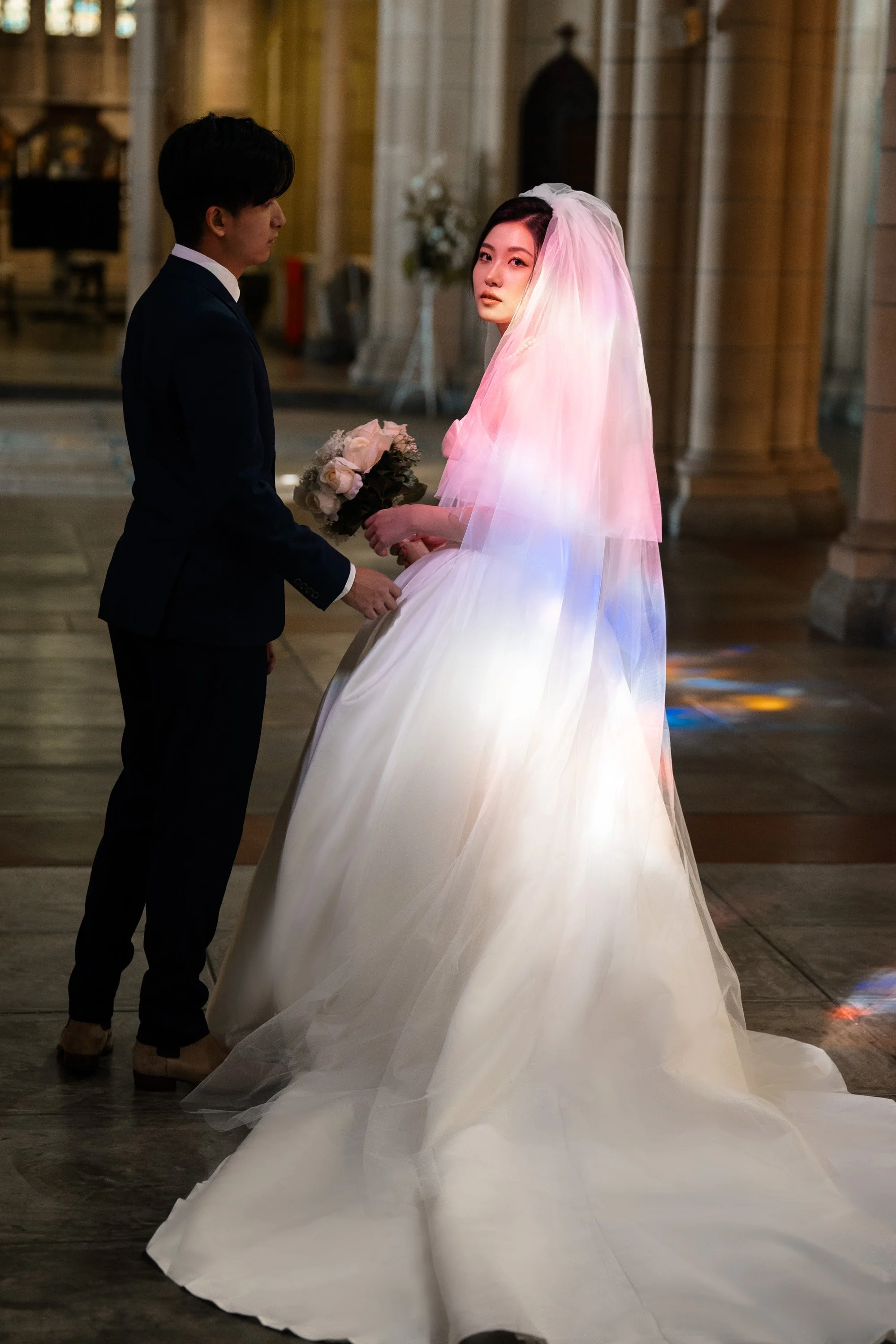 bride look at the wedding photographer Whistler when groom look at her