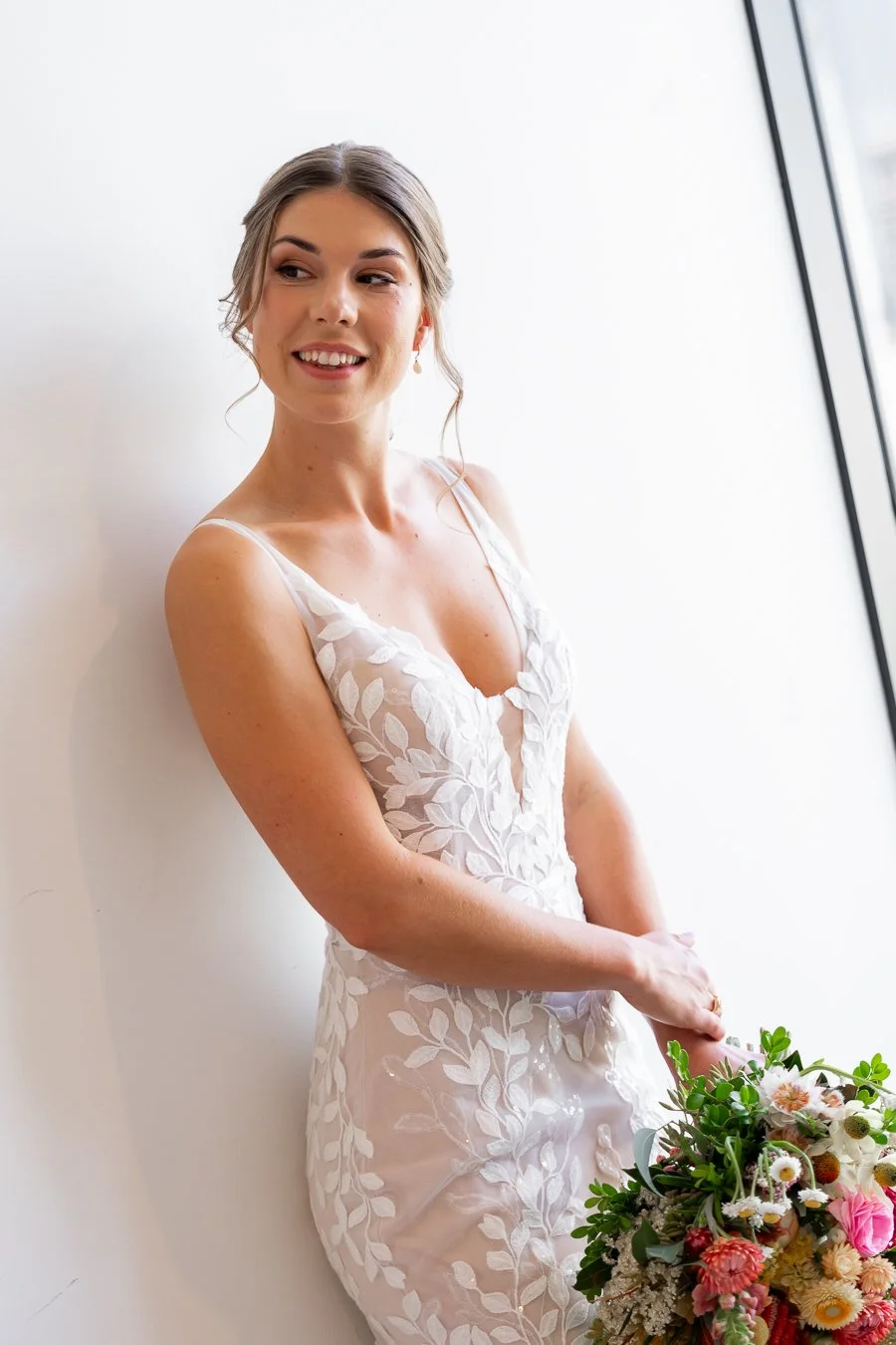 The bride playfully glanced toward the door
