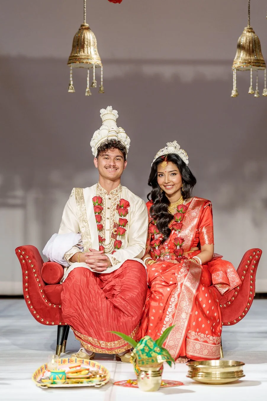 Amrita and Casey sitting next to each other look at the Brisbane wedding photographer Whistler Li