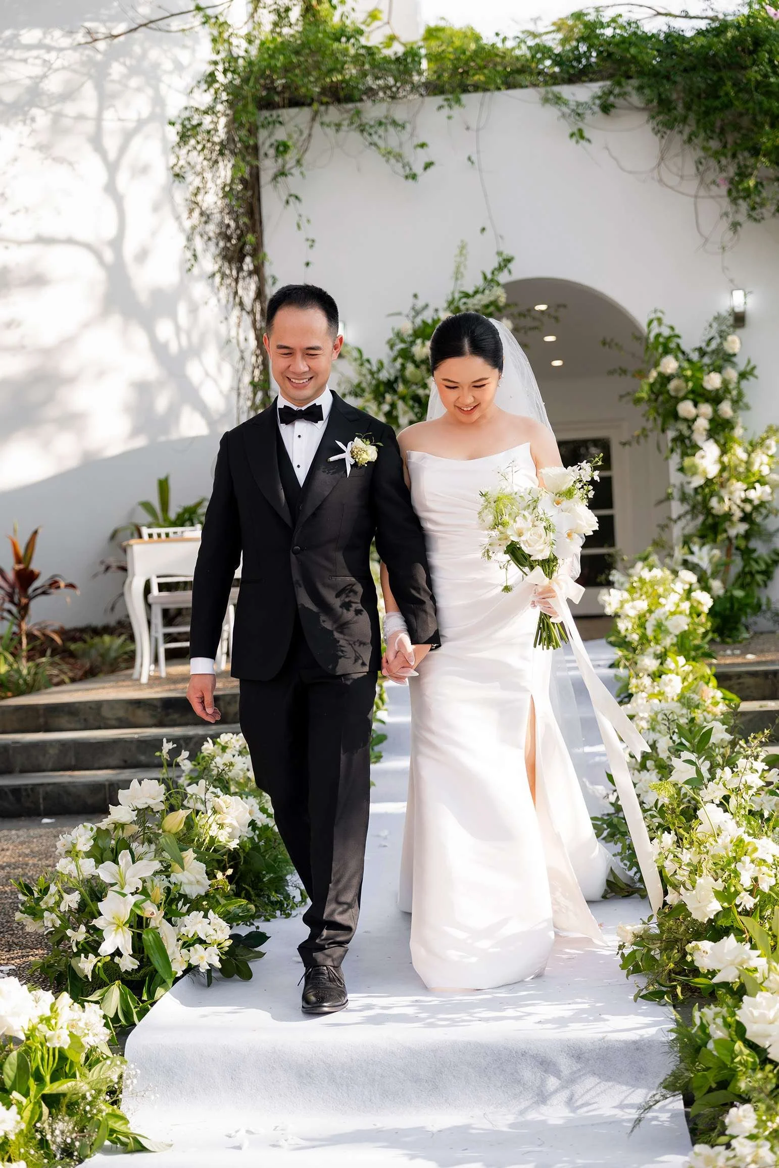 Wendy and Alex holding hands walking down the stairs after the wedding ceremony