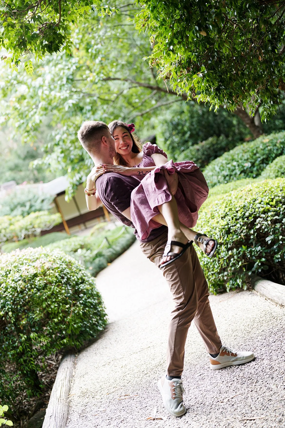 Kyle picked Ruby up, and they looked into each other’s eyes, smiling happily in Japanese garden Brisbane Botanic Gardens Mt Coot-tha