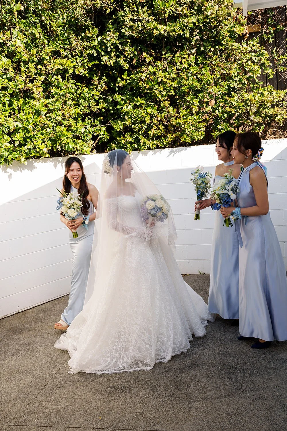 Lisa's brides mates walking towards to her, while she under her veil 