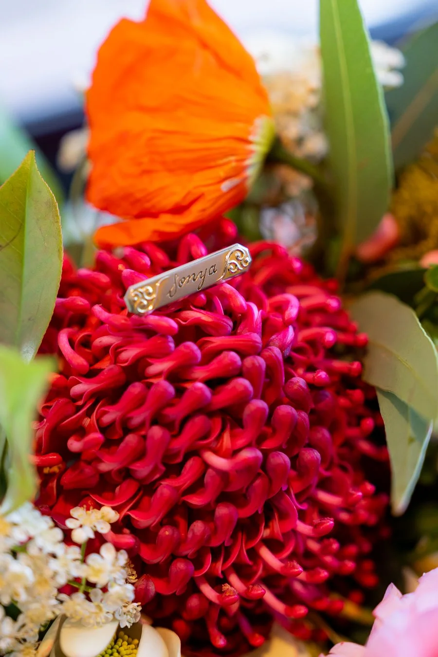 The bride’s name tag, displaying her name, was placed on a flower