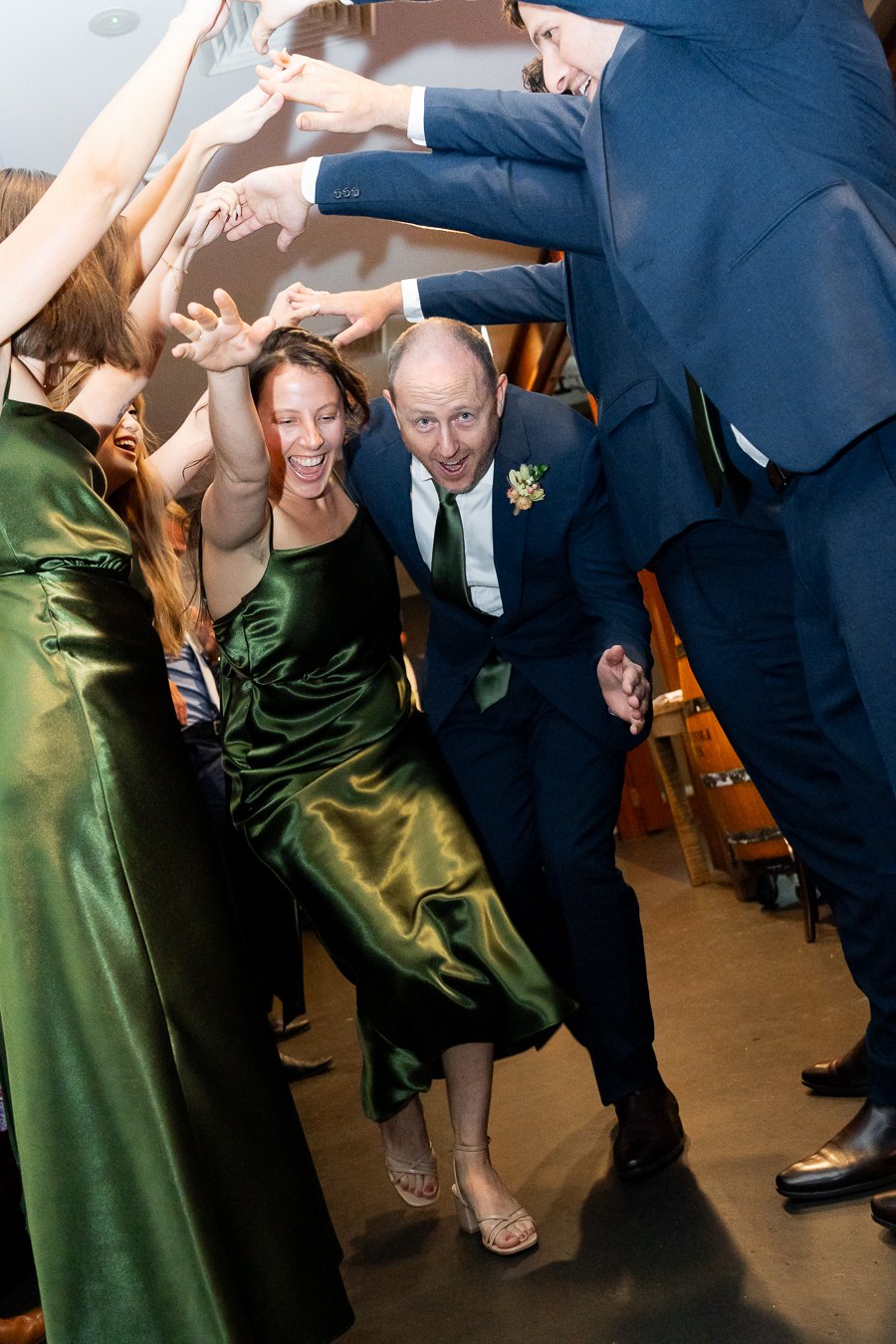 humen arch with bridal party walking in