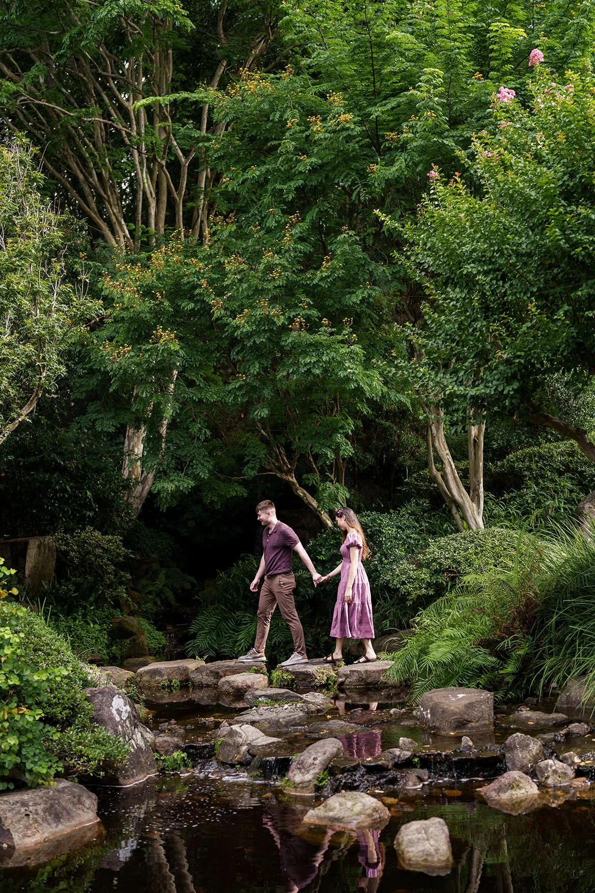 Kyle holding Ruby's hand walking on the rocks