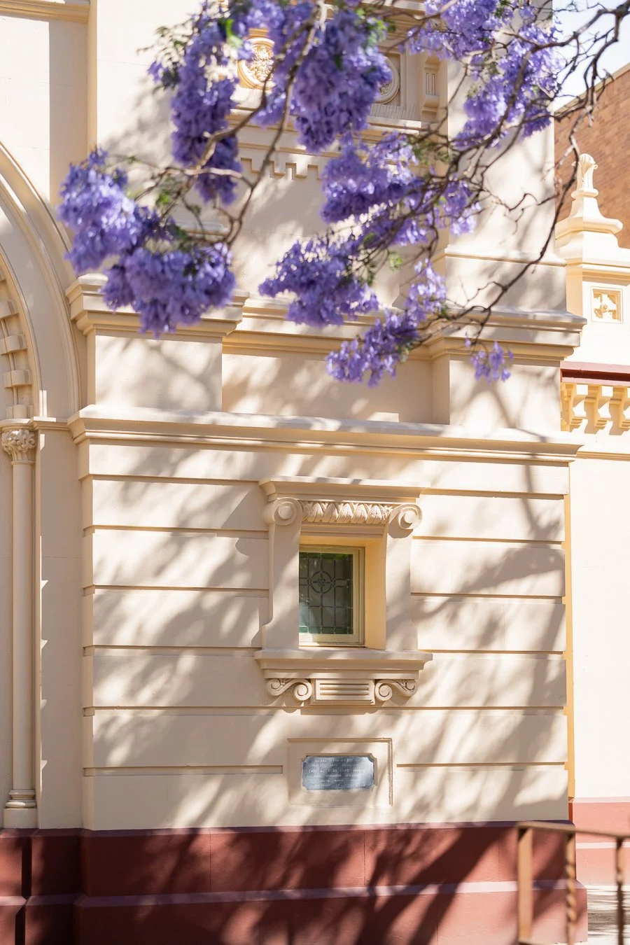 The shadows of jacaranda trees fell on the St Mary's Catholic Church walls