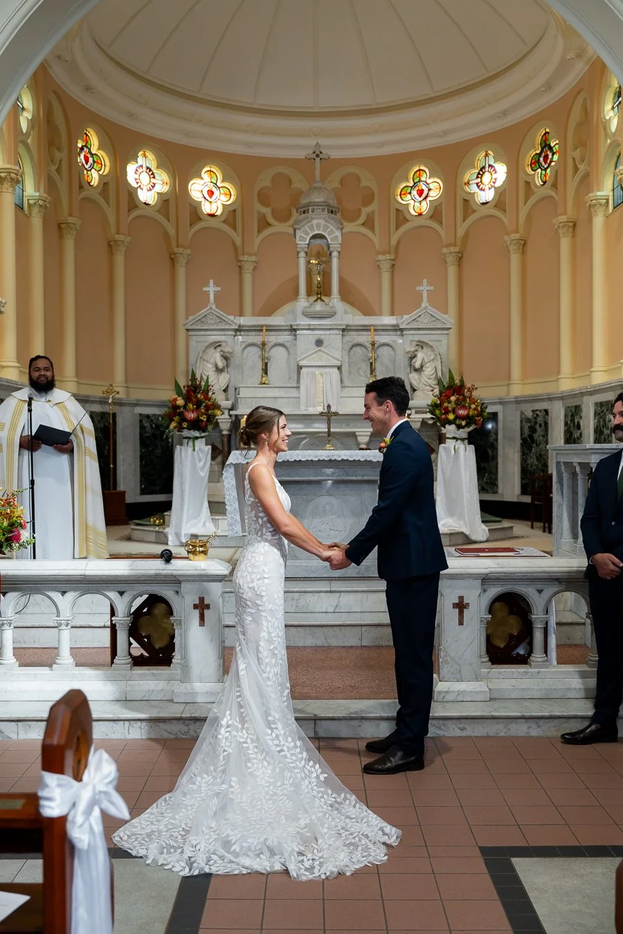 The bride and groom faced each other, smiling joyfully