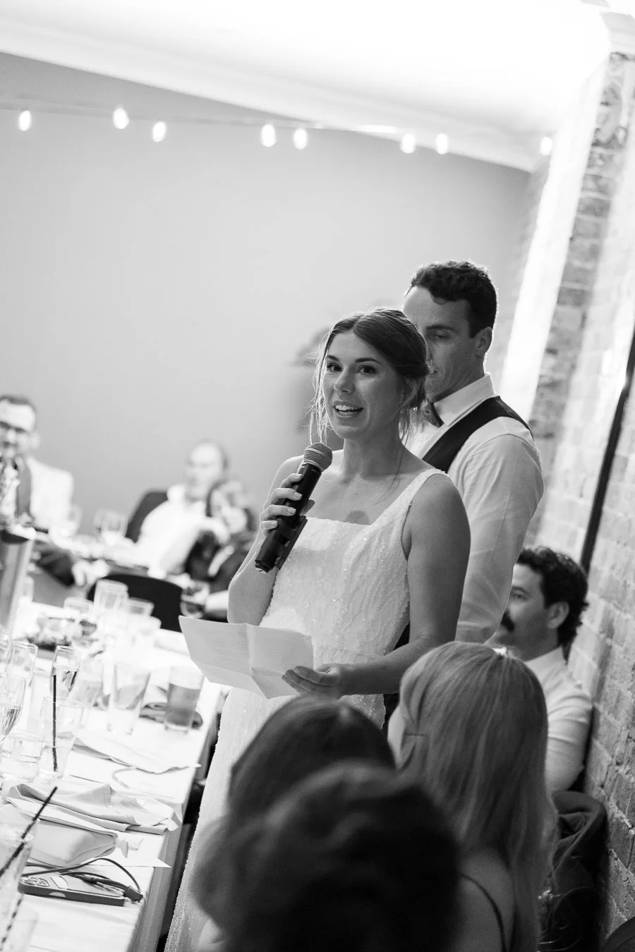 bride Sonya speak on a mic while look to the guest