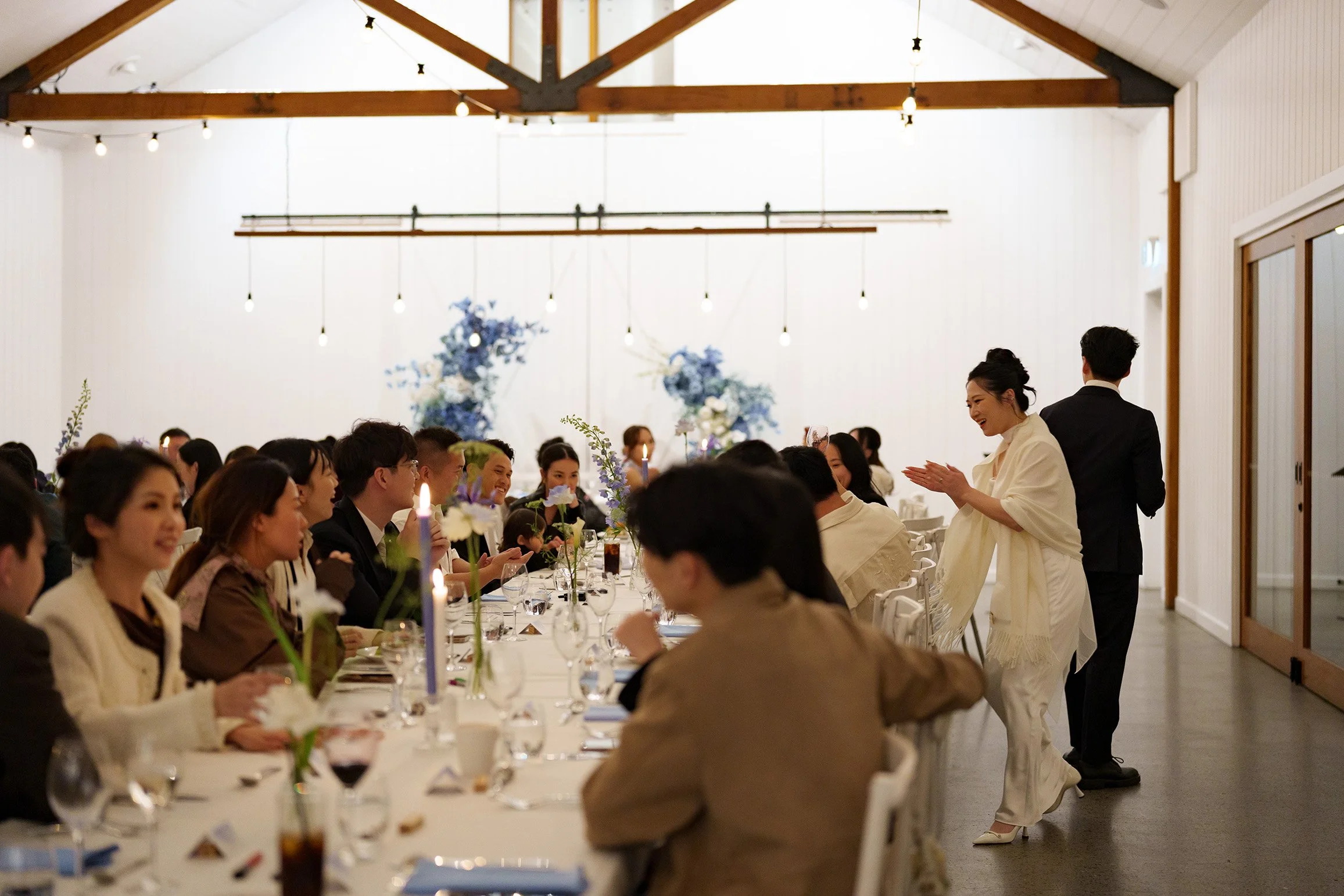 Lisa clapping to her guest in reception