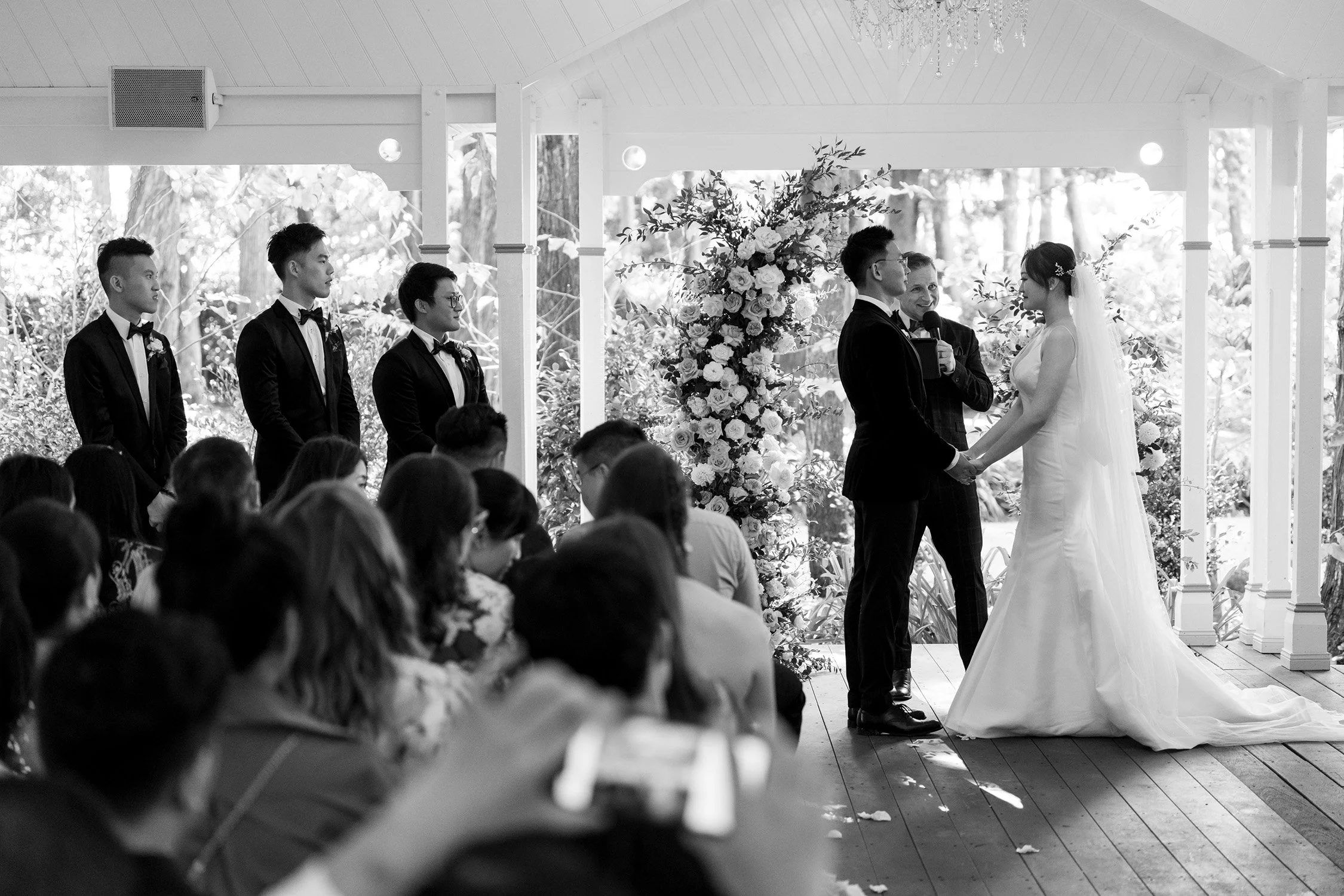 bride and groom holding hands in ceremony