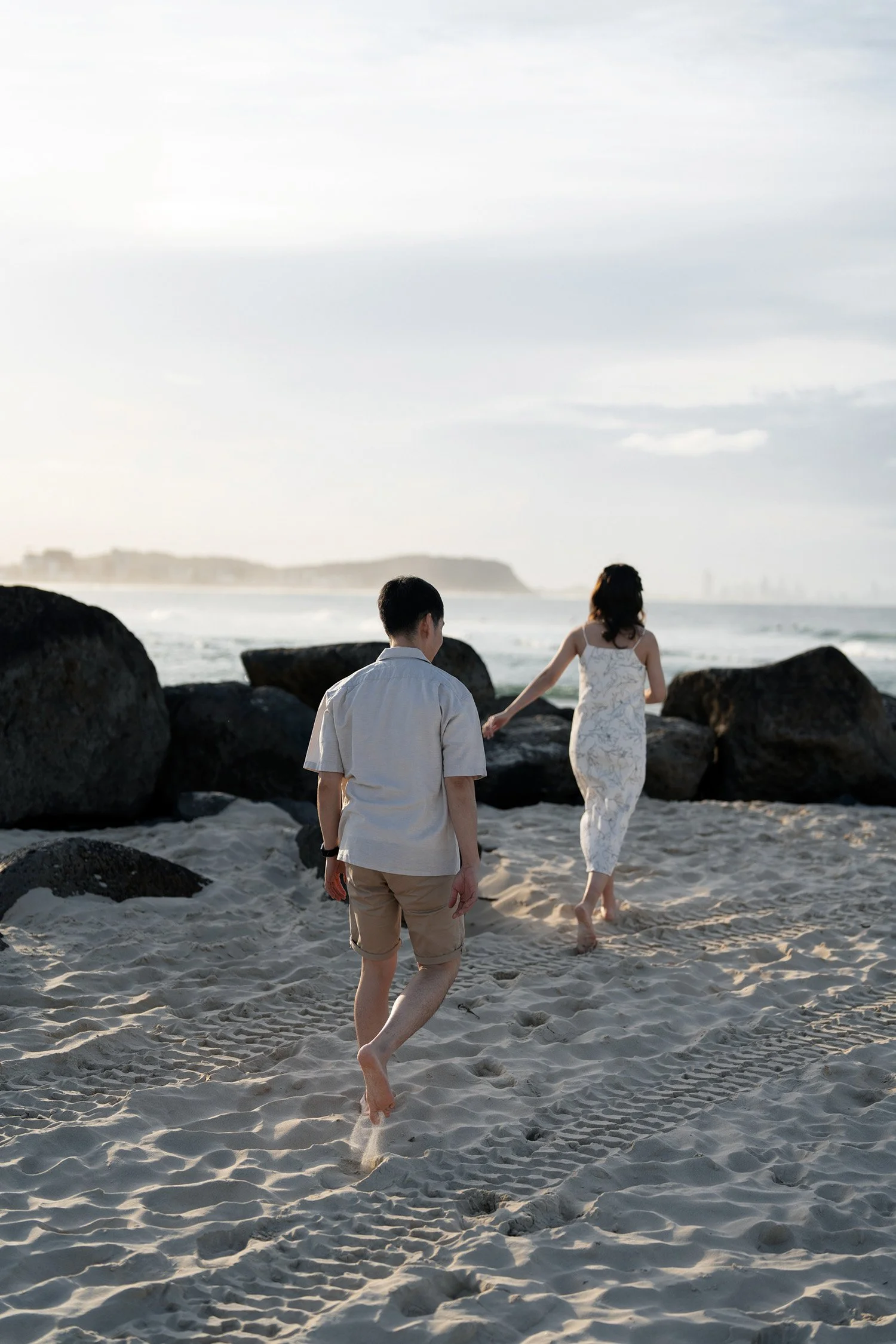 Paul and Krystel walking away from the camera towards to the rocks