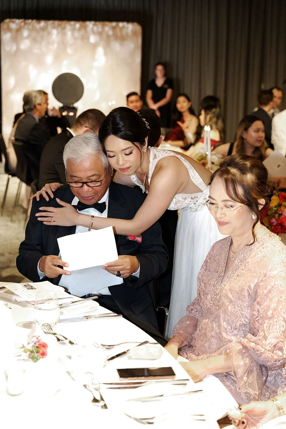 bride Nori holding her father from back and touching his forehead