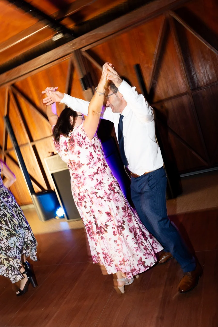 two guest raising their arm dancing