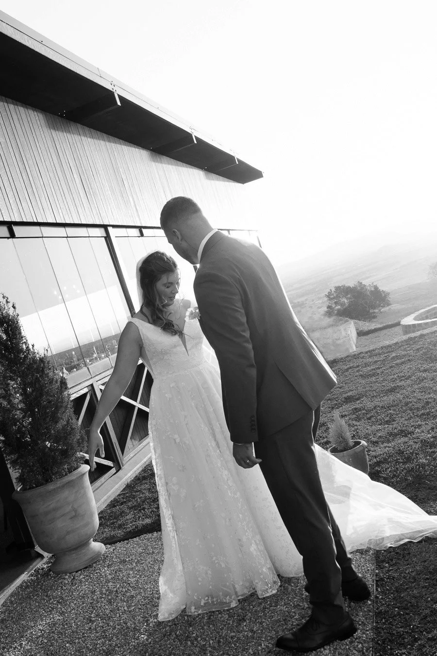 bride Chiarra naturally fluffy her wedding dress showing to the groom Ben