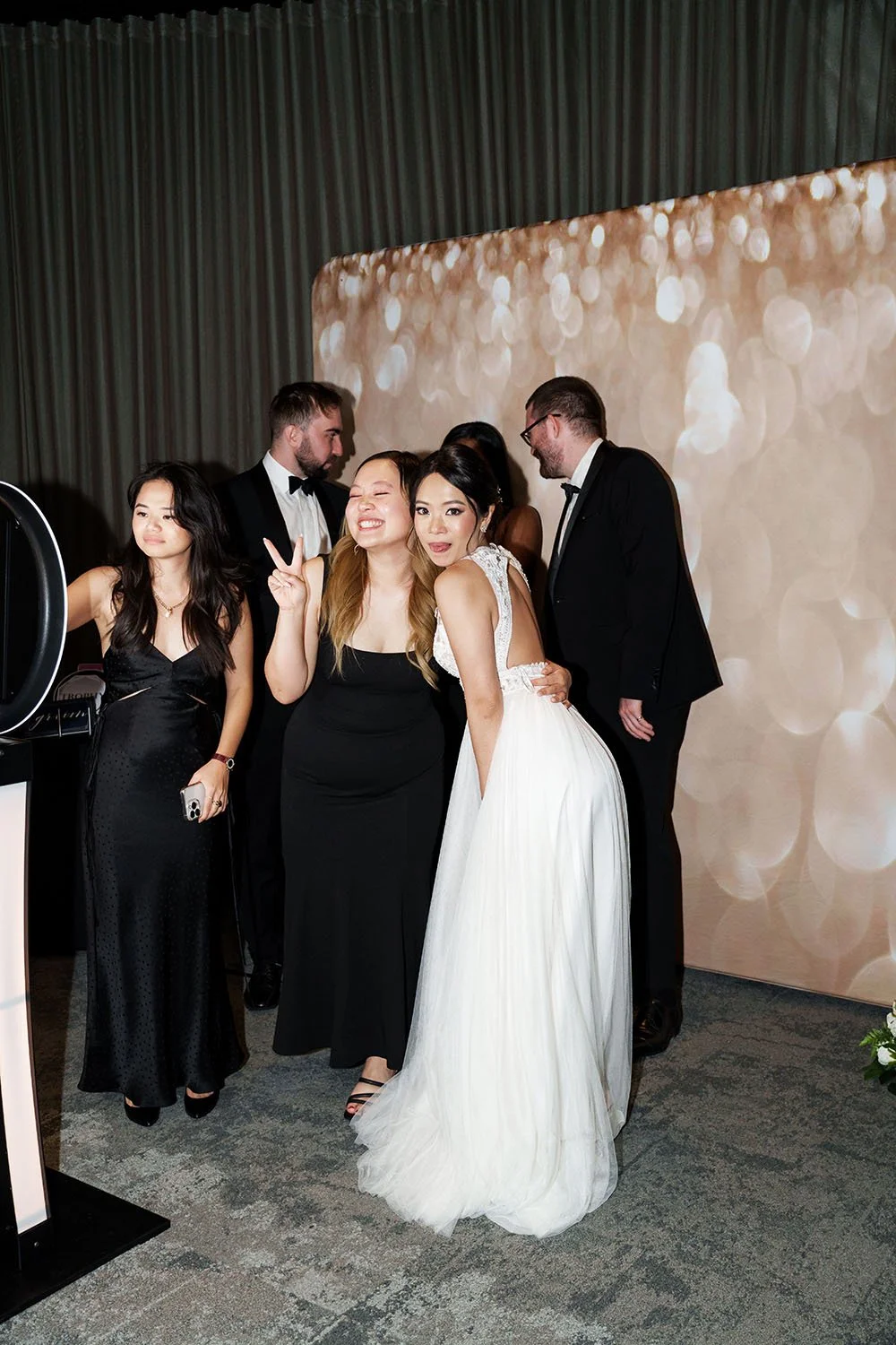 bride Nori making a cute face the the camera in front of the Photo Booth
