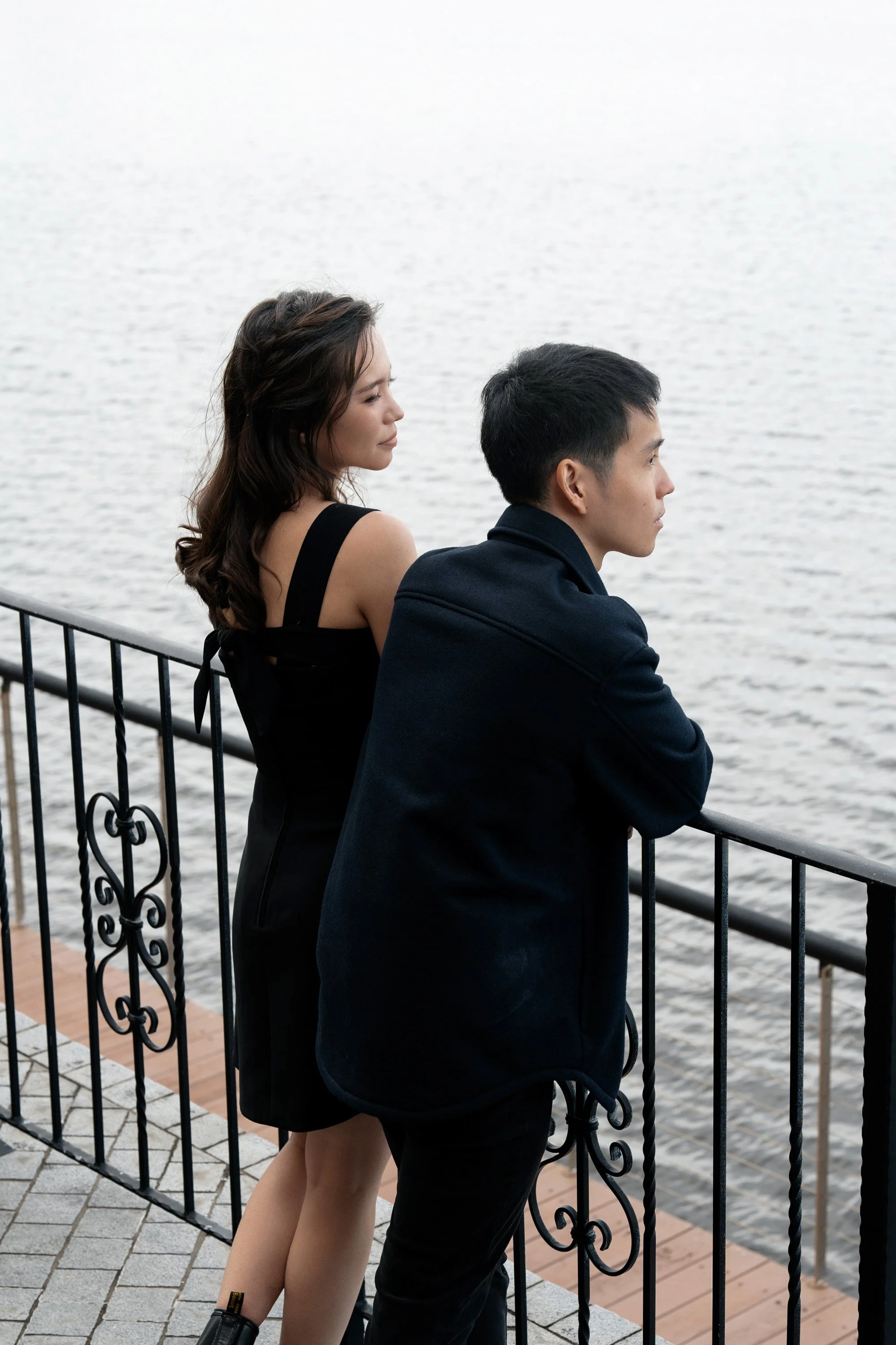 Paul and Krystel stand next to a railing and look at the Emerald Lakes