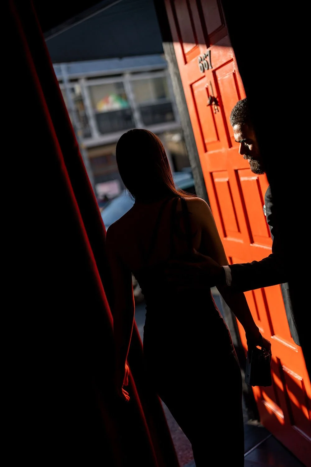 Jasmin walking out of the red door, Jay open it for her and look at her