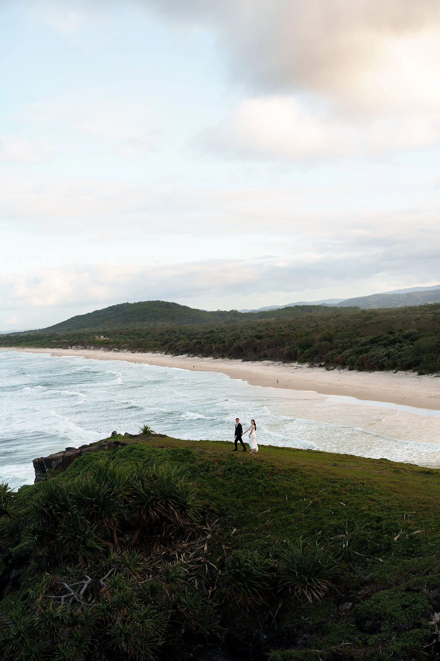 Silva holding Margaret's hand leading her walking forward when she look back to the Brisbane wedding photographer Whistler Li