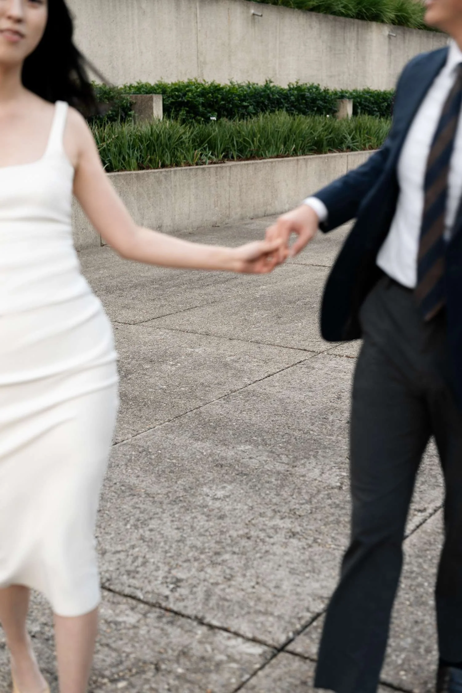Kath and Dave running towards the camera, sharing a joyful and carefree moment, their laughter and excitement captured in motion.