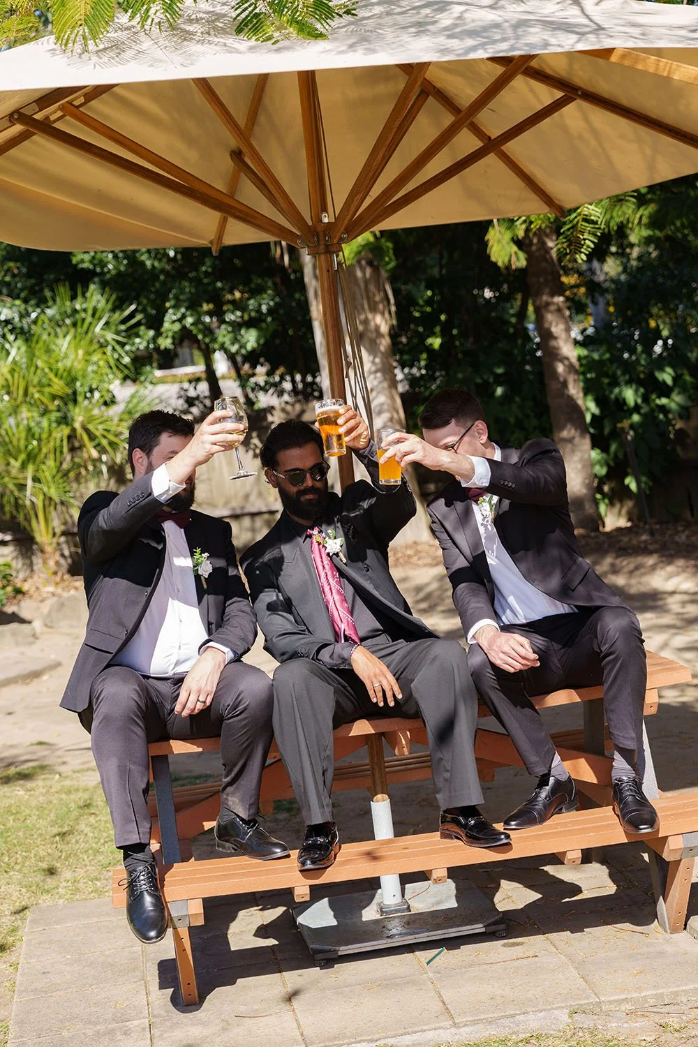 Jay and his groomsmen cheers and glaees up