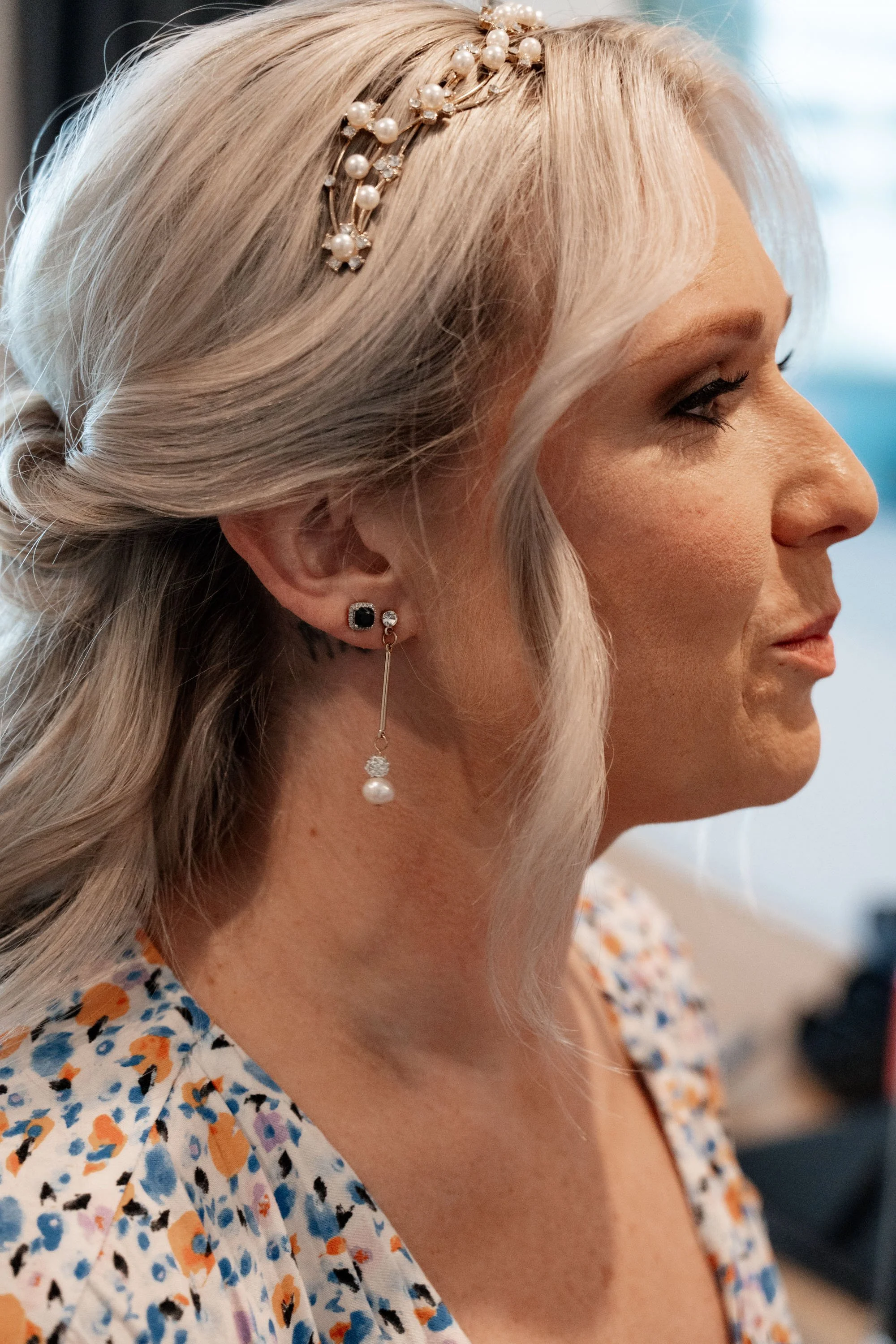 Side view of the bride, capturing her profile in her wedding dress, showcasing her elegance and grace on her special day