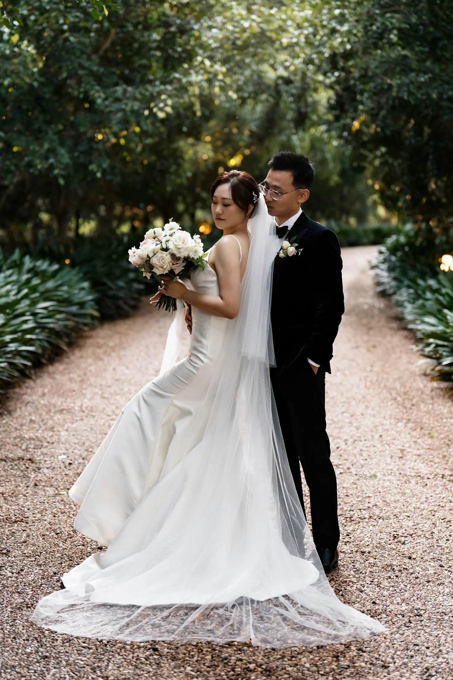 bride Vicky's back against Brus and look down to her flower