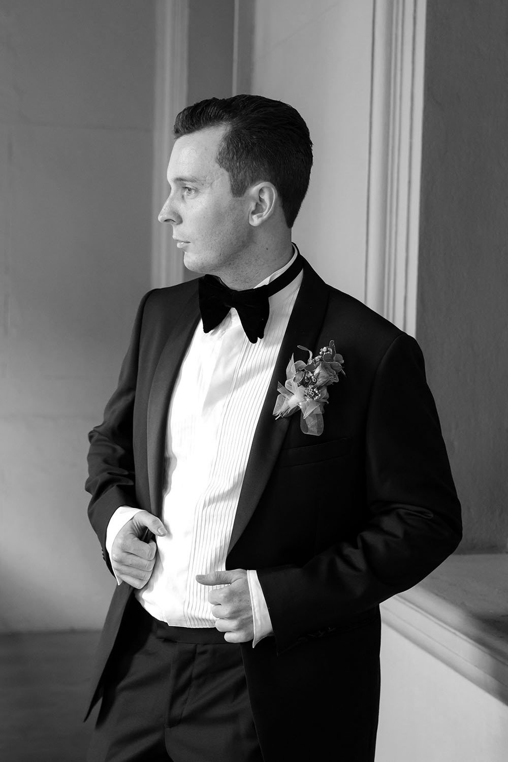groom Cliffe two hands holding the jacket look away
