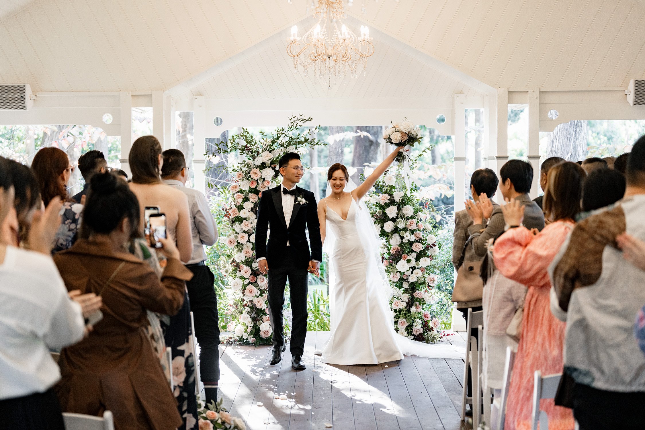 bride Vicky hands up and all guests claps for them after the ceremony in Gabbinbar Homestead