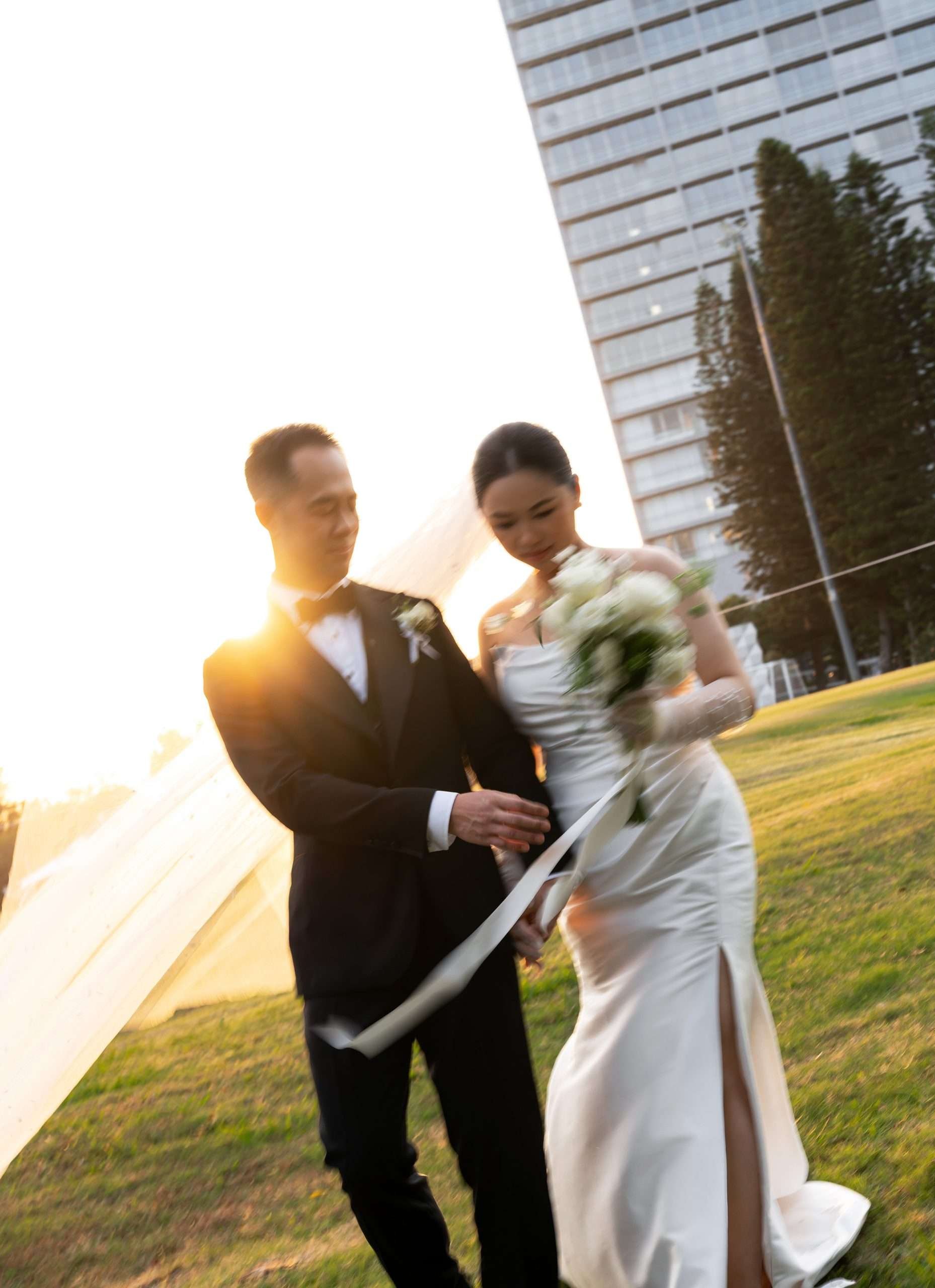 Alex and Wendy holding hands walking towards to the Brisbane wedding photographer Whistler Li