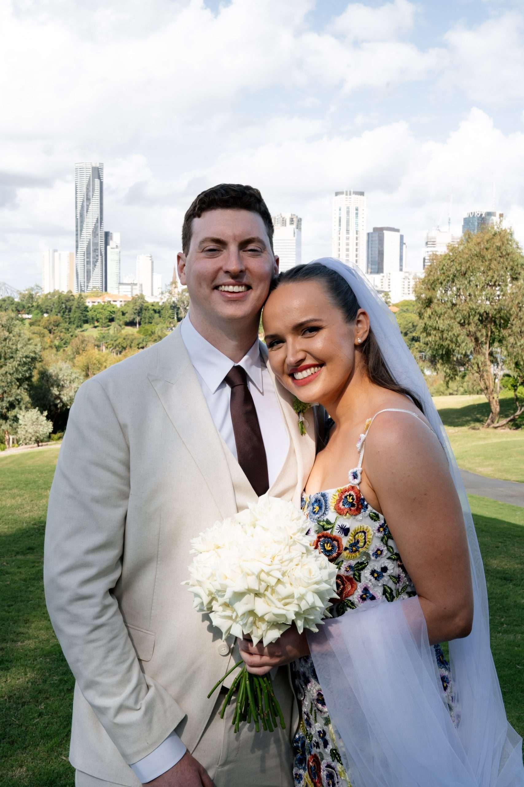 Bride and groom leaning toward each other while looking at Brisbane wedding photographer Whistler.