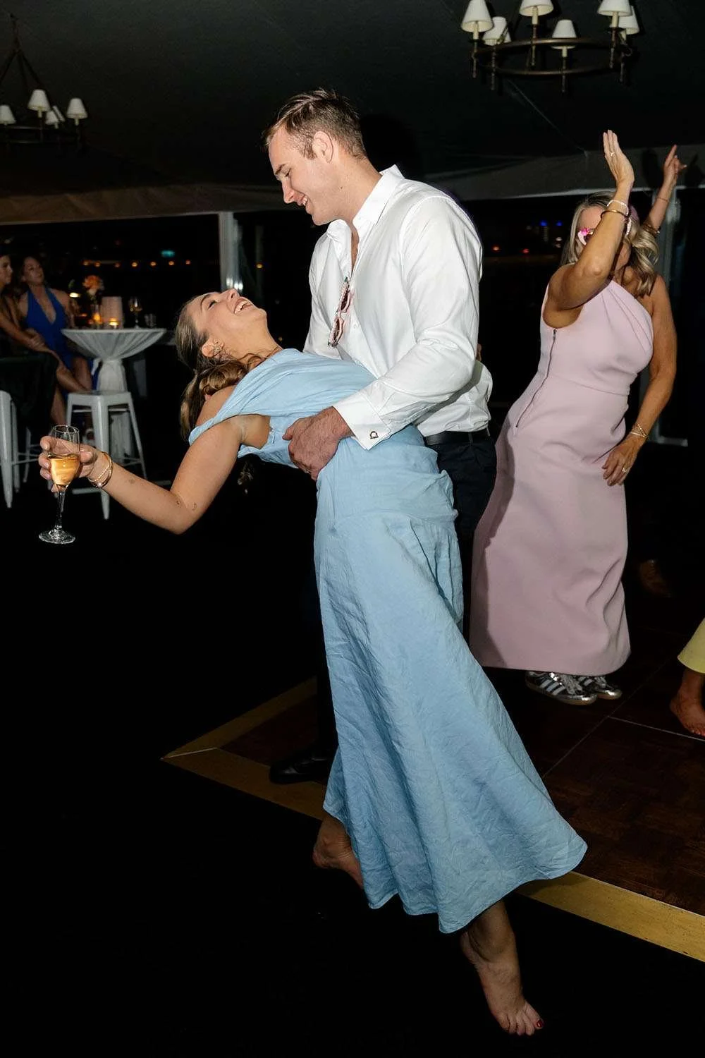 a male guest dipping his girlfriend in dance floor