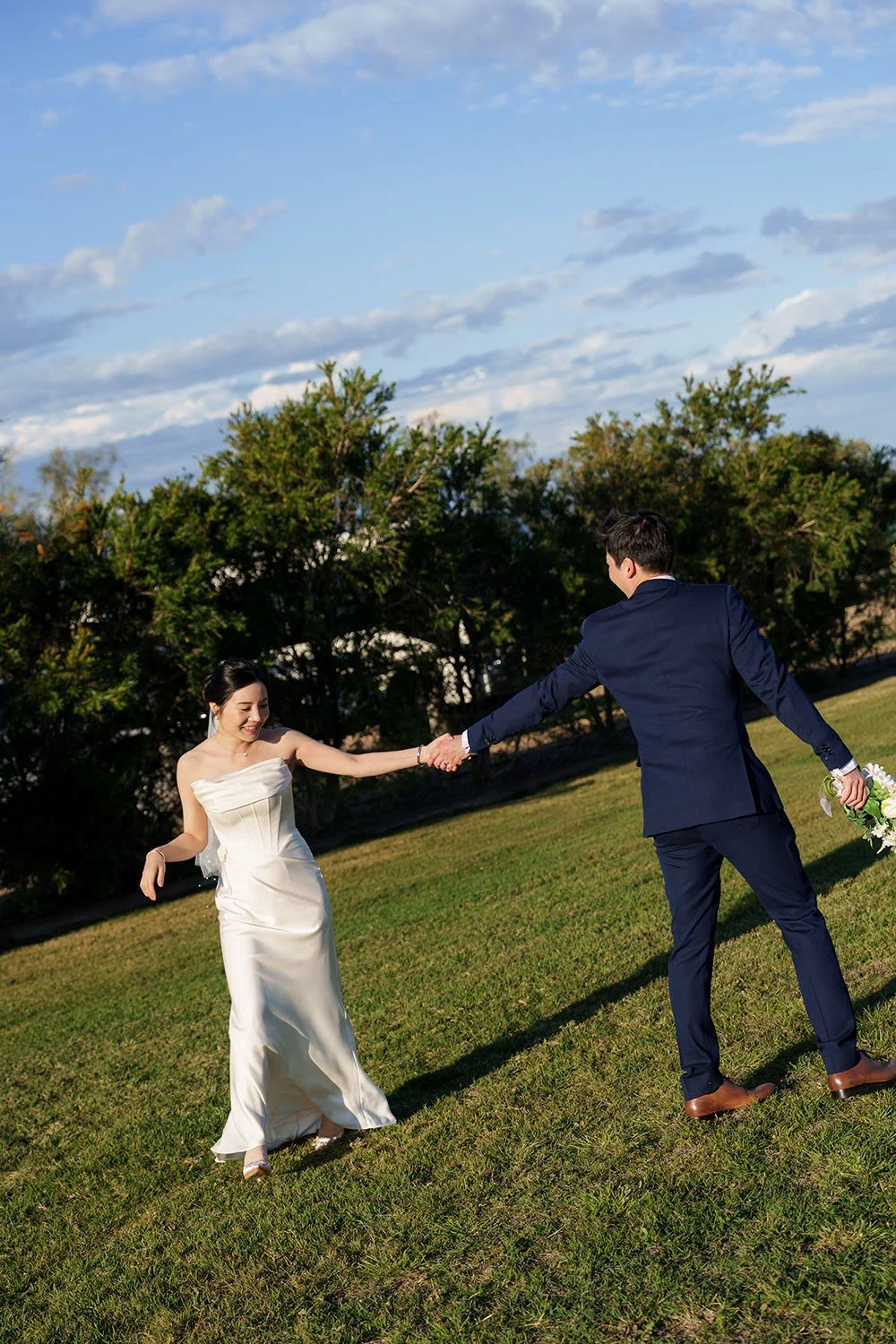 bride Flora and groom Eric held each other with straight arms and spun around with laughing