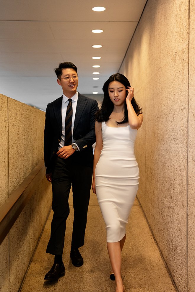 Kath pull back her hair and Dave walking behind her and look at her