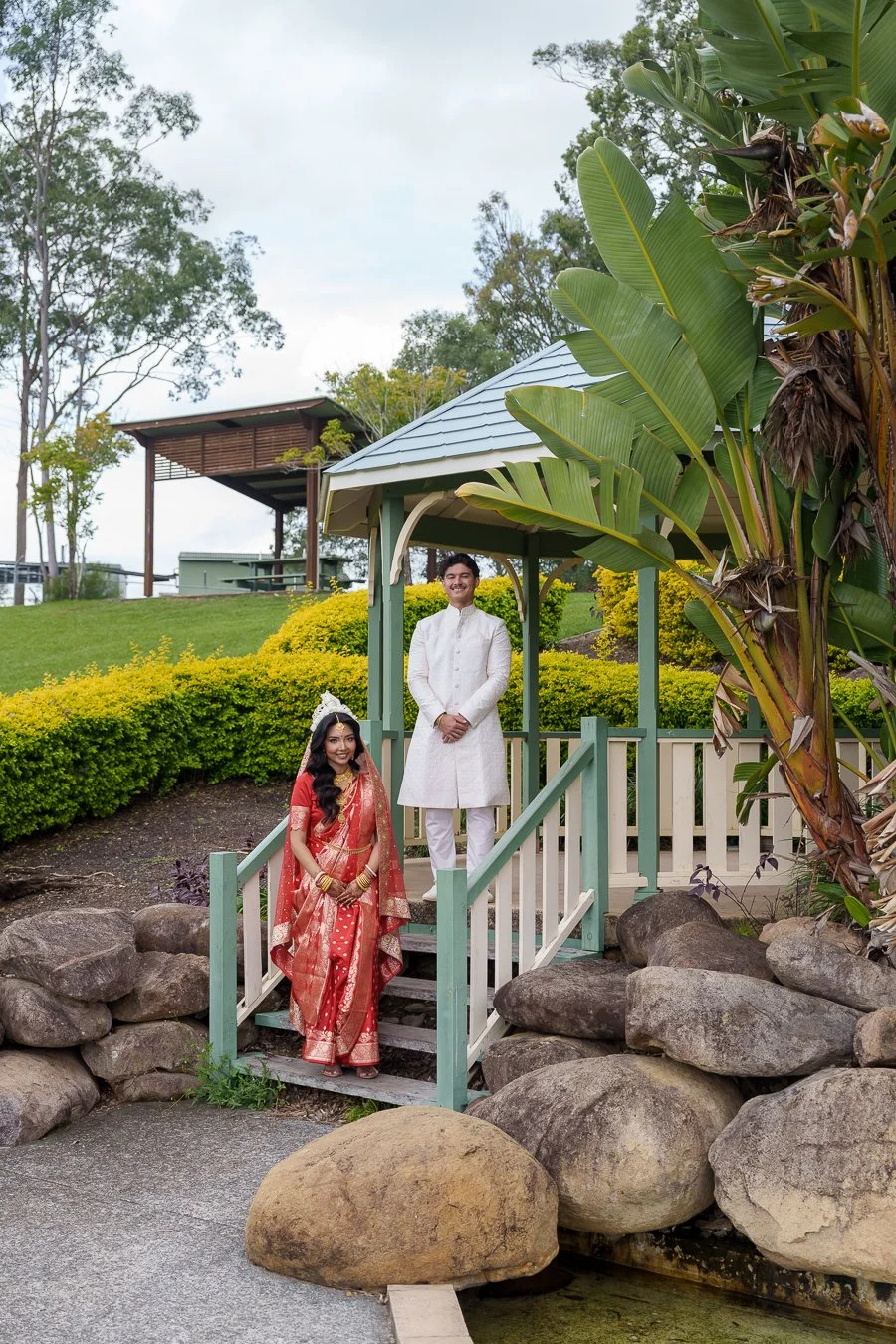 Casey stand on the very top stair hands in the front and Amrita stand in the first and they both look stright ahead