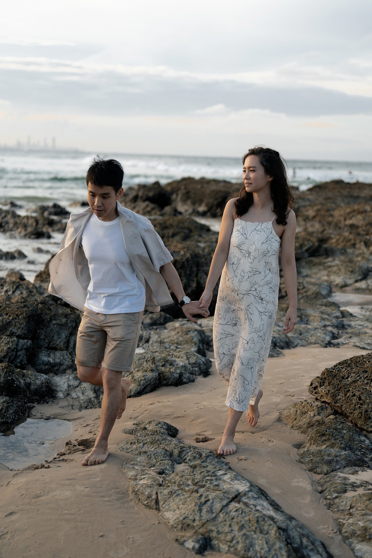 Paul leading Krystel walking and she look at him, Brisbane engagement photography